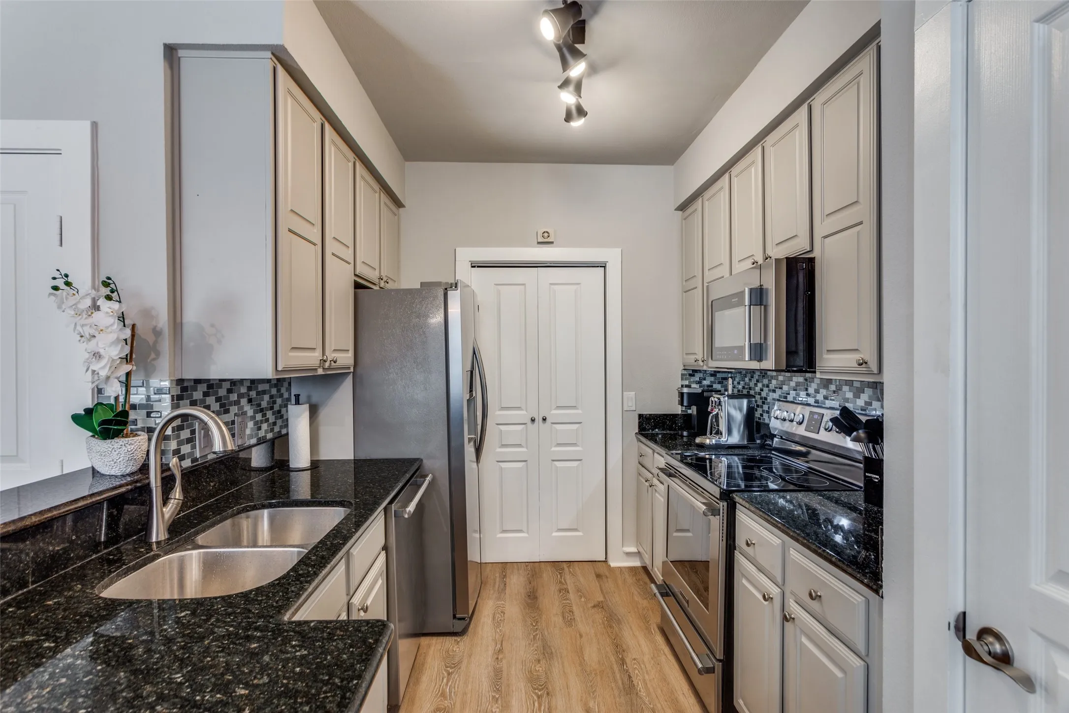 There is a full size laundry room beyond the doors. New flooring, faucet and liighting.