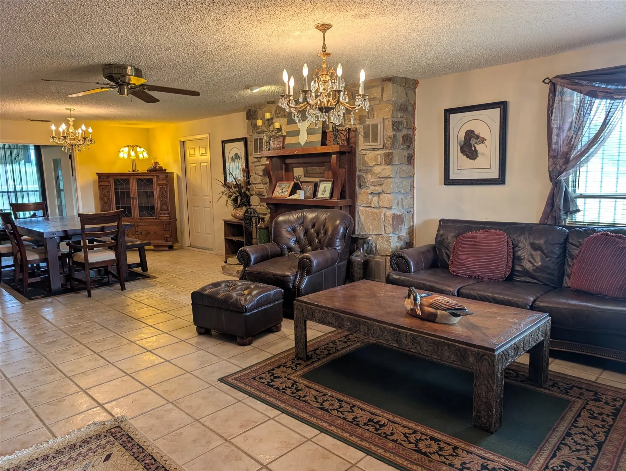 Large living/dining combo with tile floor and fireplace
