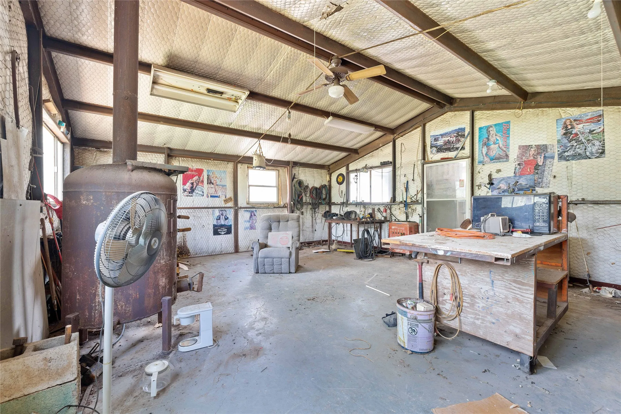 Garage with a workshop area and a ceiling fan