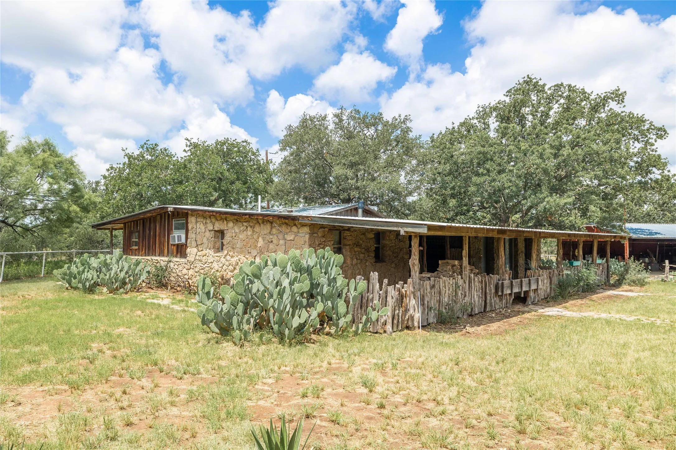 View of property exterior with stone siding