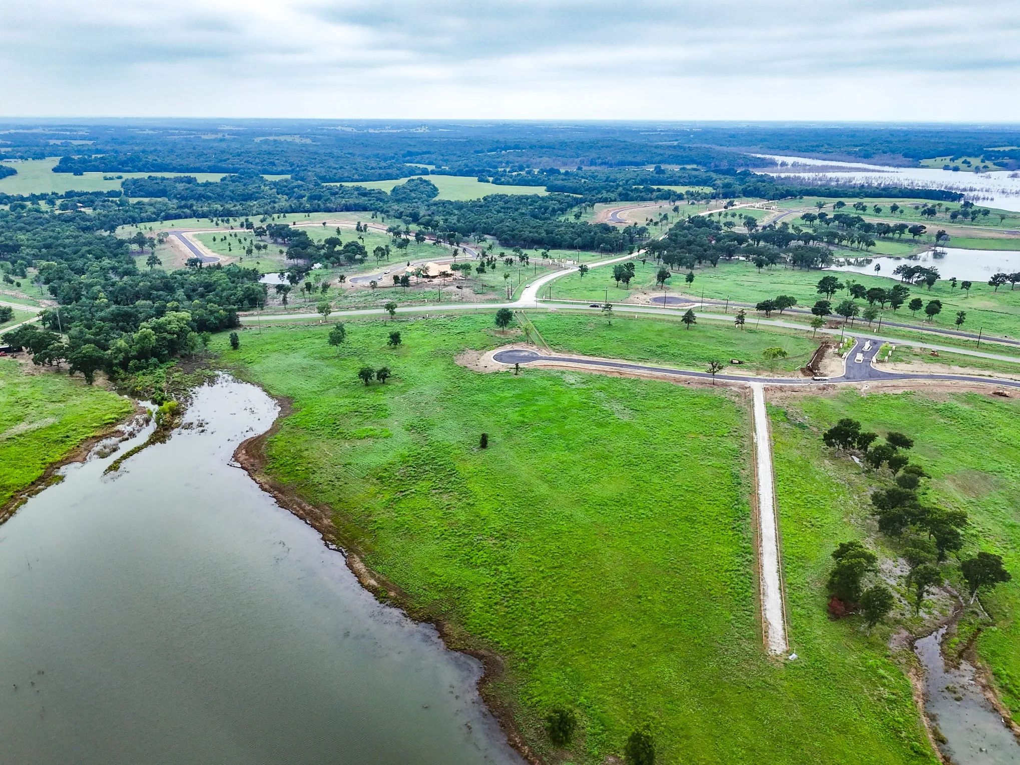 Aerial view of sparsely populated area with a large body of water