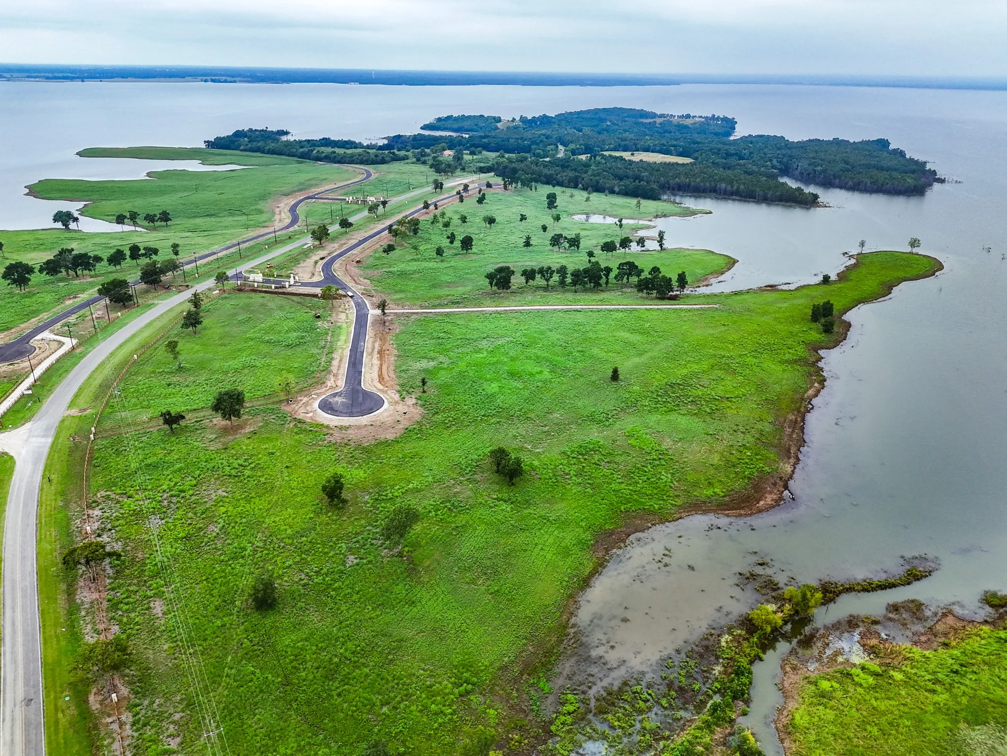 Aerial overview of property's location featuring a large body of water