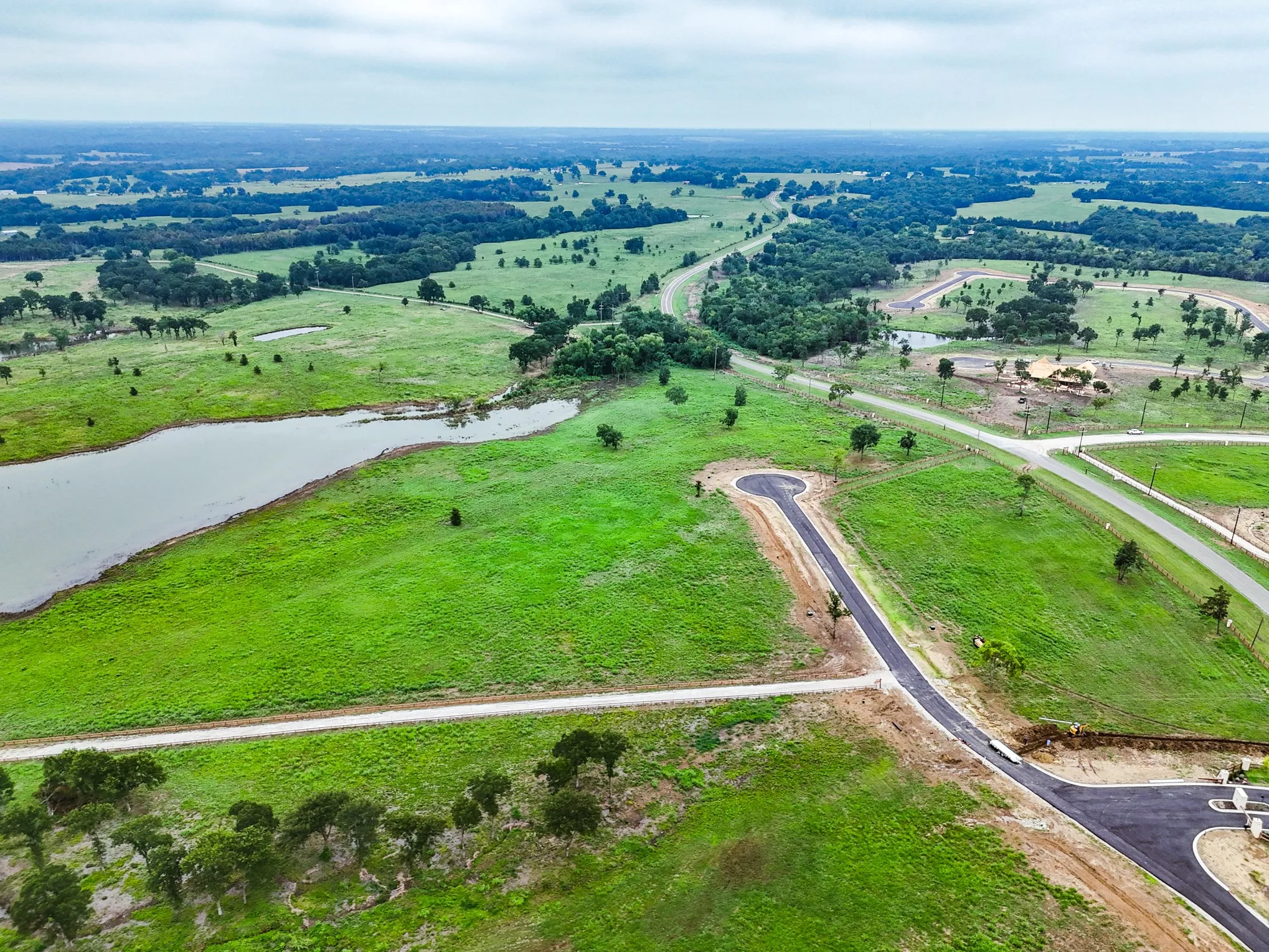 Overview of rural landscape featuring a nearby body of water
