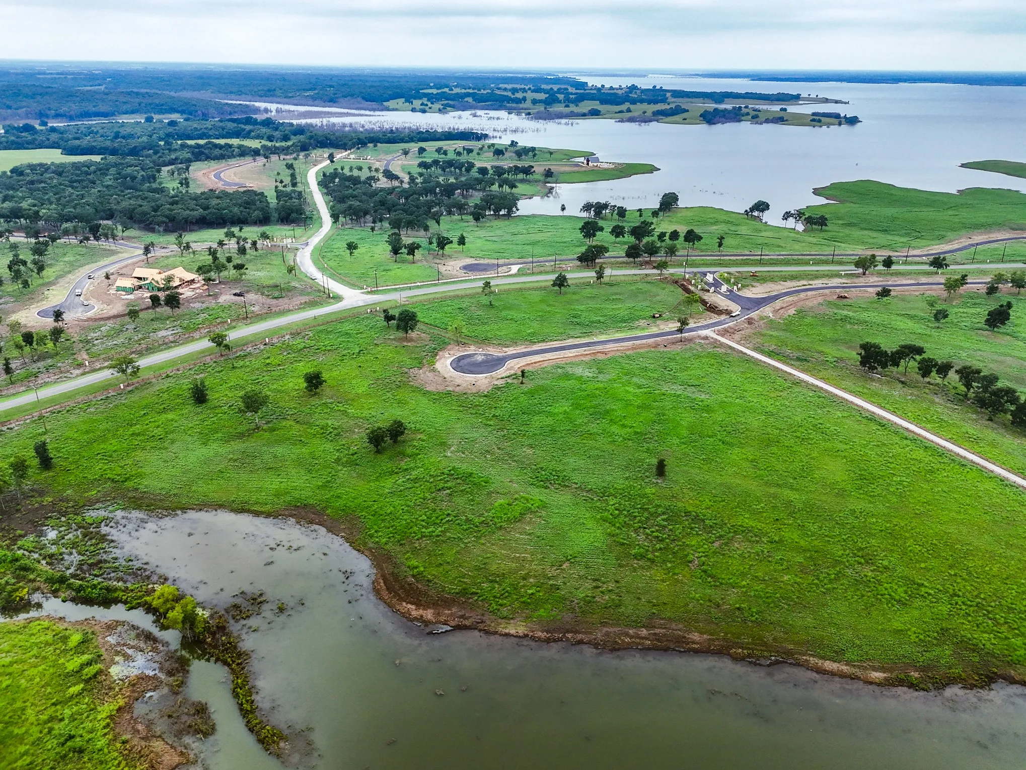 Aerial overview of property's location with a nearby body of water