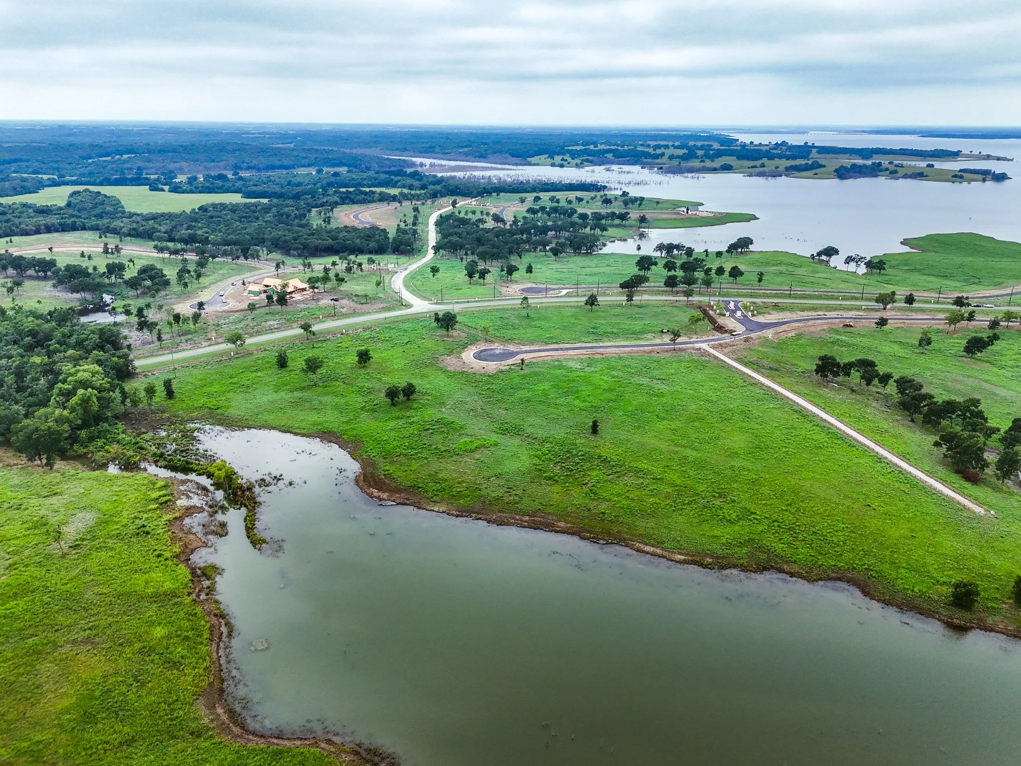 Aerial view of sparsely populated area featuring a nearby body of water