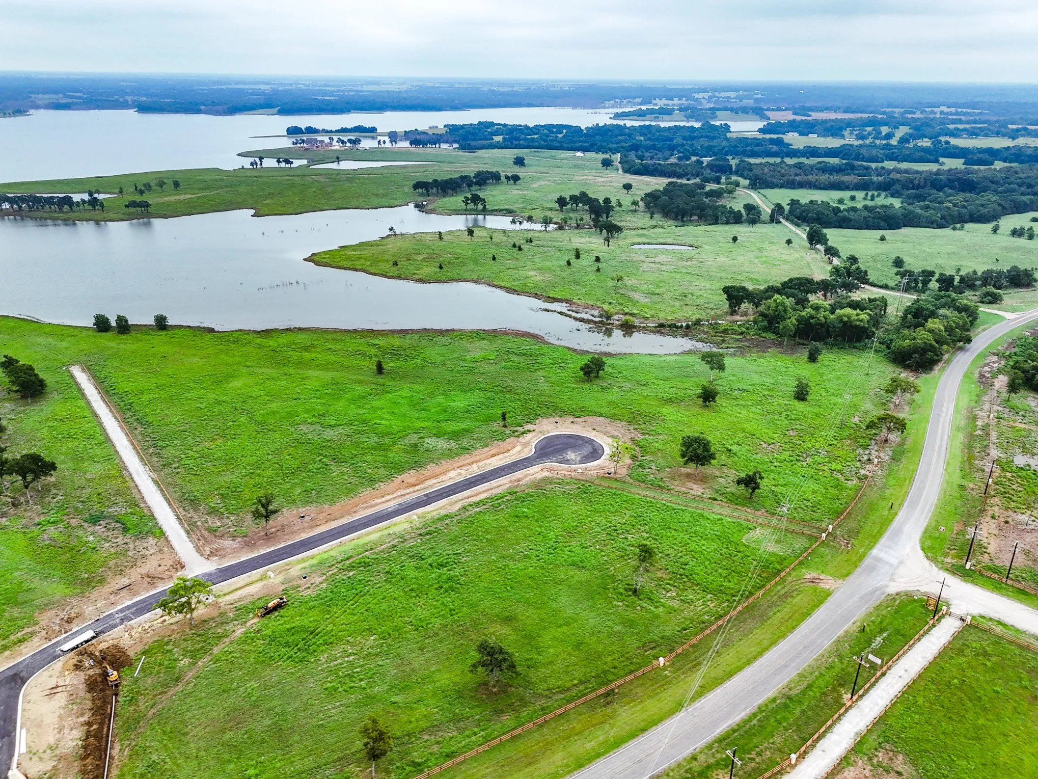 Aerial view of sparsely populated area featuring a nearby body of water