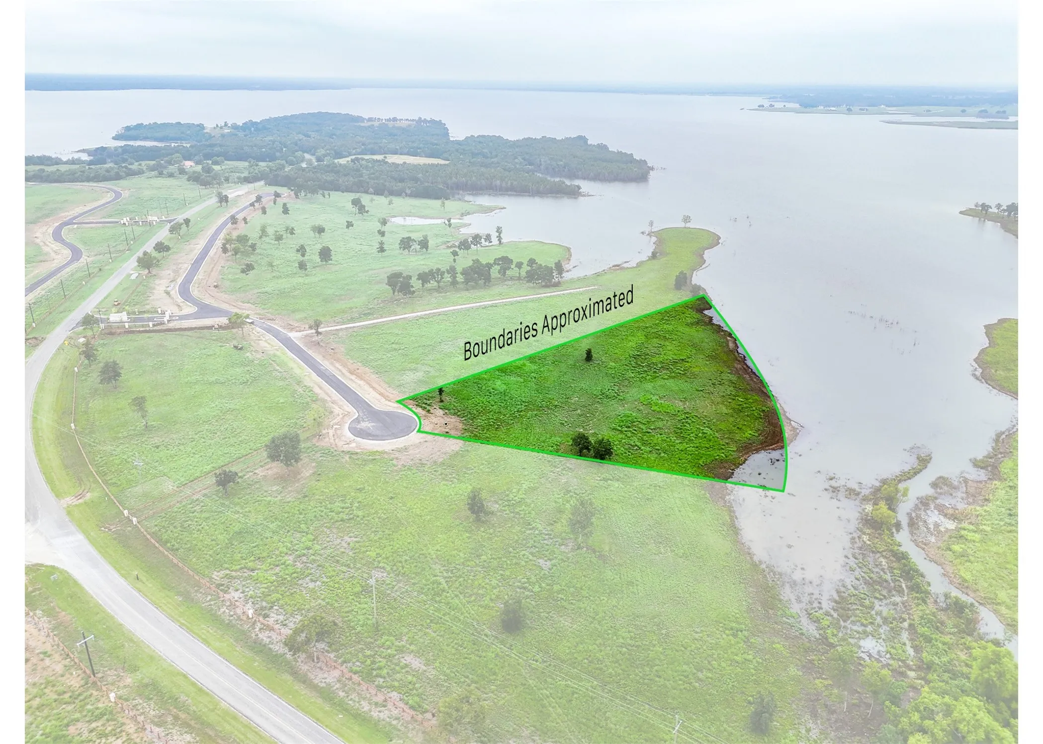 Aerial overview of property's location featuring a large body of water and property parcel outlined