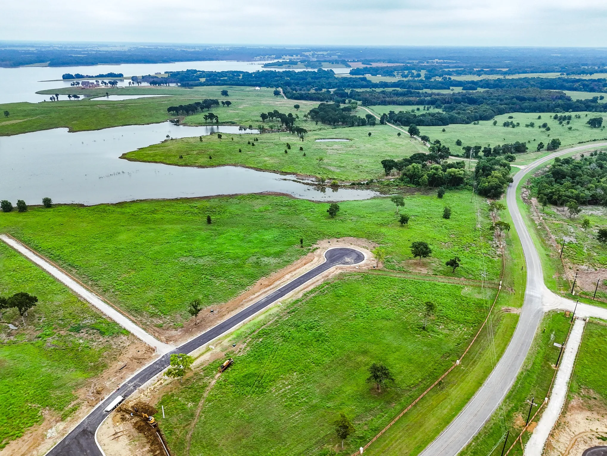 Aerial overview of property's location with a large body of water and rural landscape