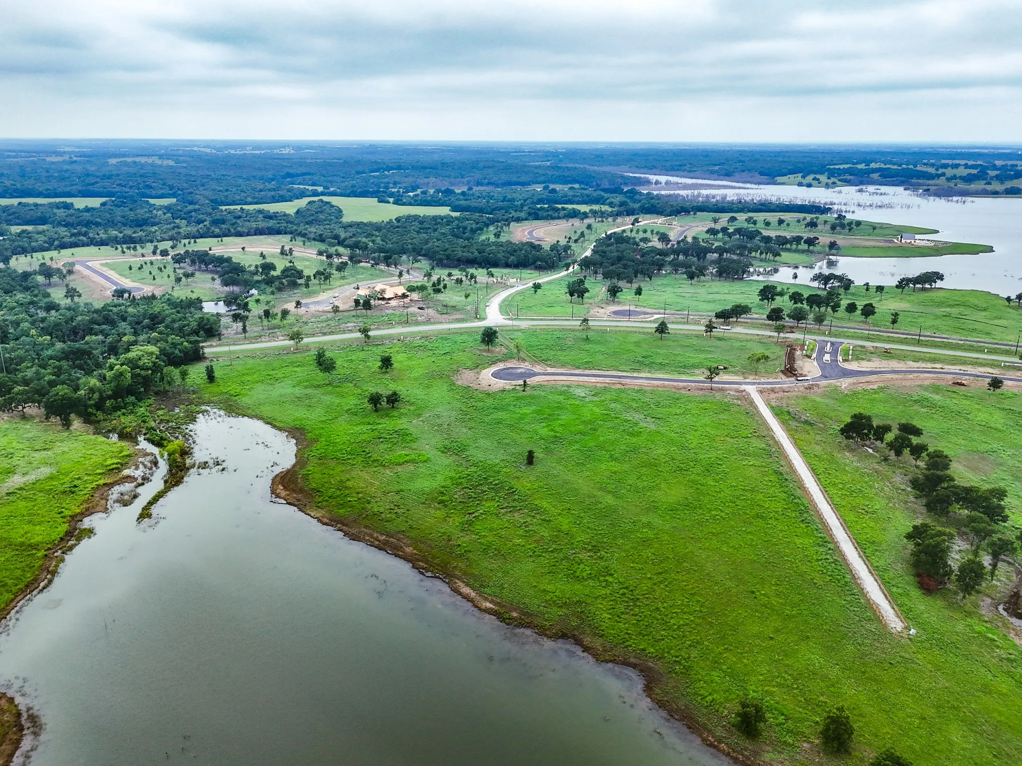 Aerial overview of property's location featuring rural landscape and a nearby body of water