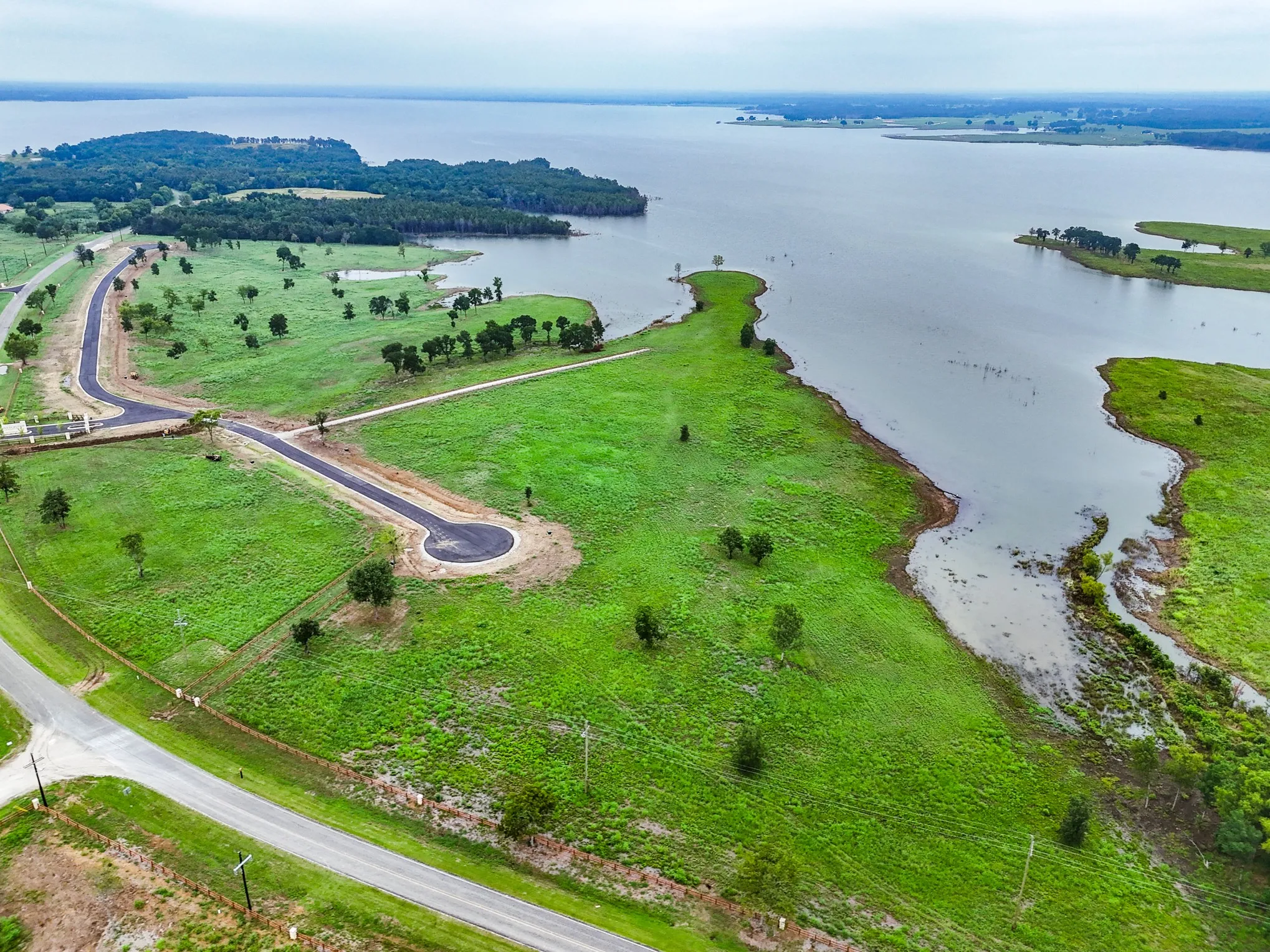 Aerial overview of property's location with a nearby body of water