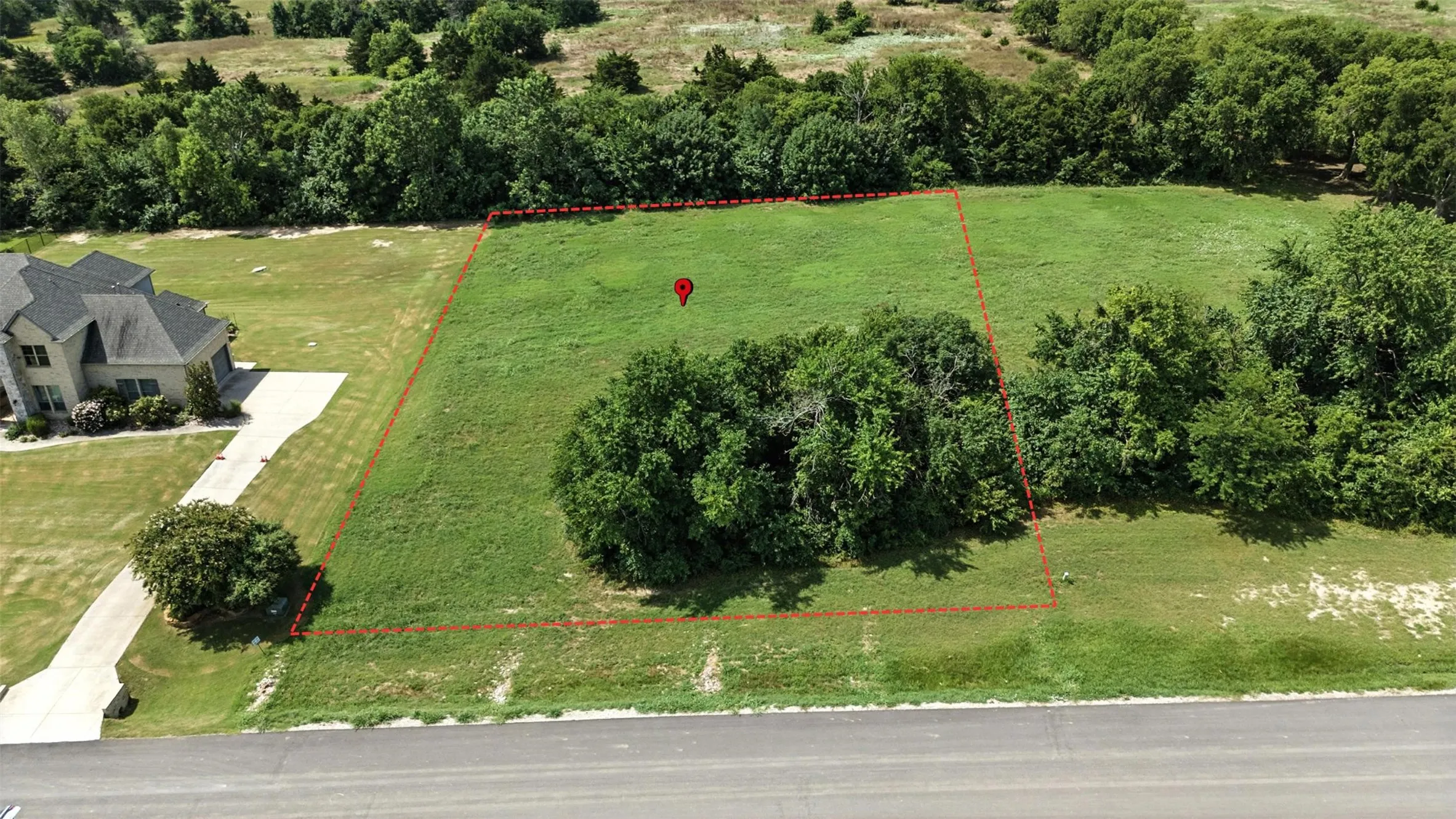 Aerial view of property and surrounding area featuring property parcel outlined