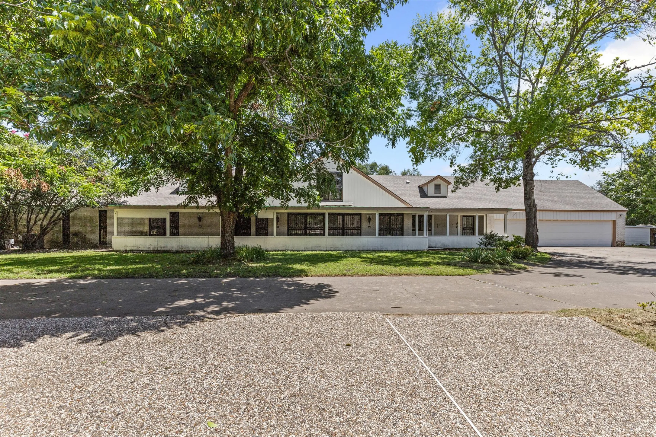 View of front of home featuring concrete driveway and a garage