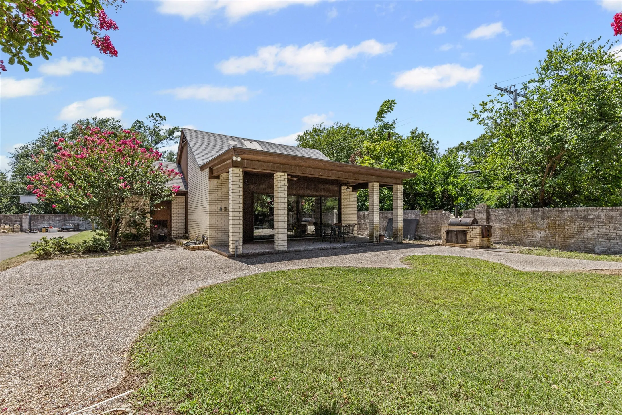 Surrounding community with a patio and curved driveway