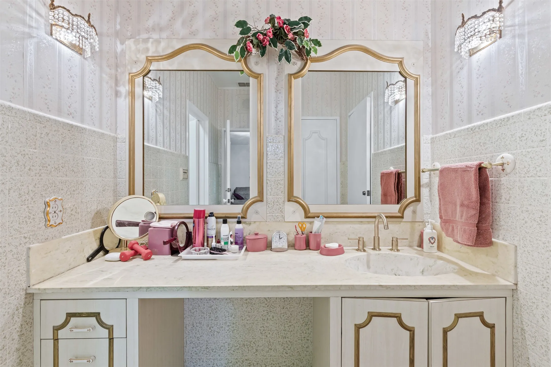 Bathroom featuring wallpapered walls, vanity, and tile walls