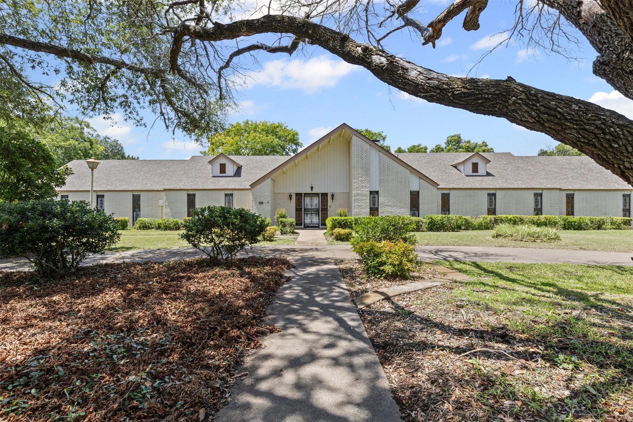 Mid-century inspired home with brick siding and a front yard