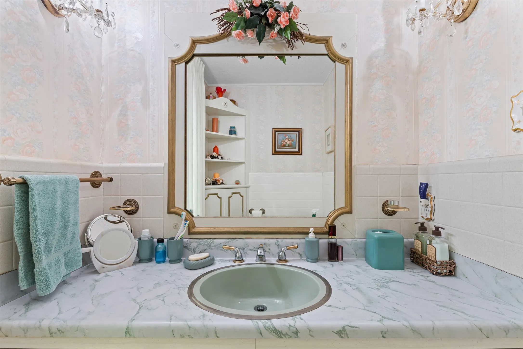 Bathroom featuring wallpapered walls, wainscoting, and vanity