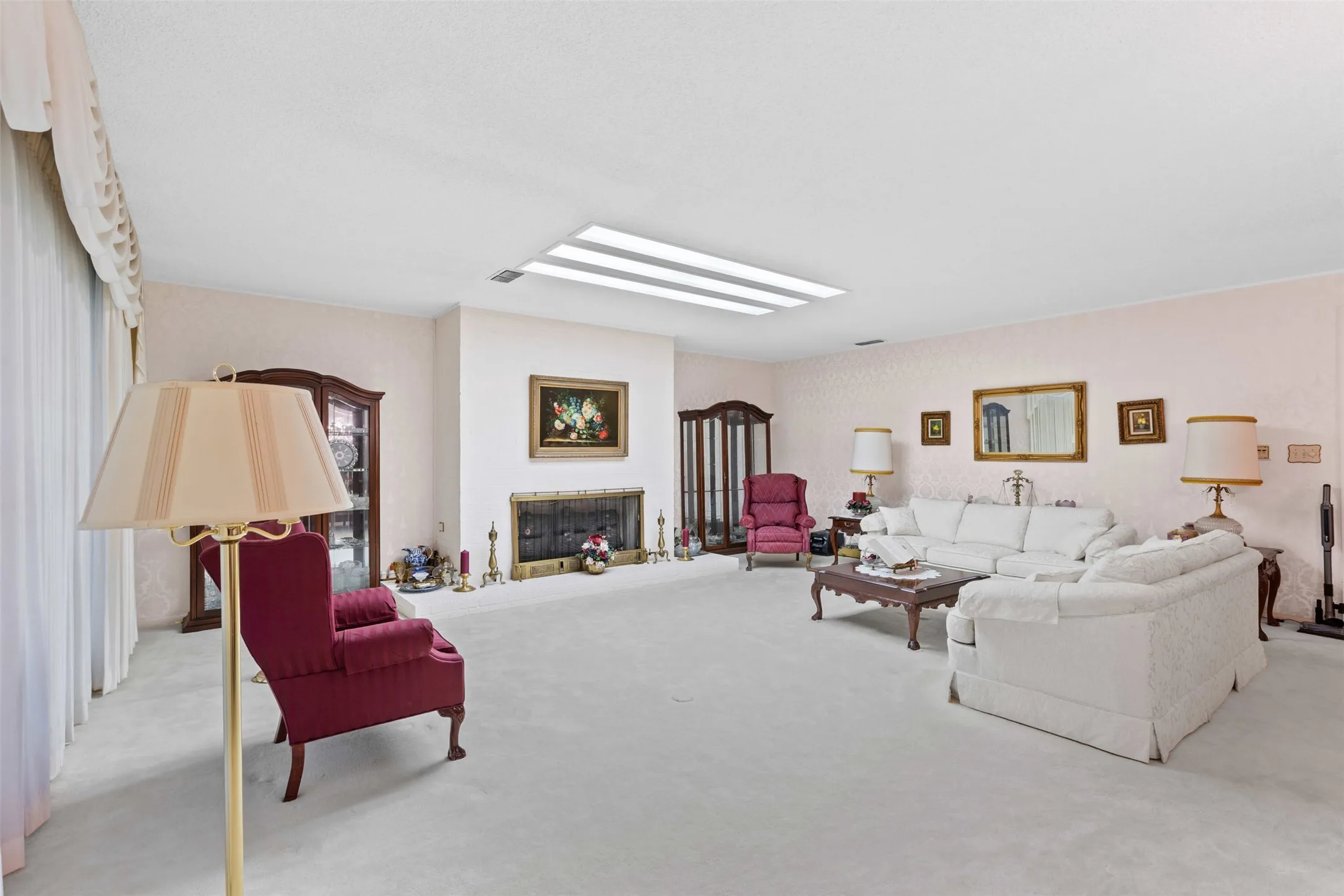 Carpeted living room with a fireplace