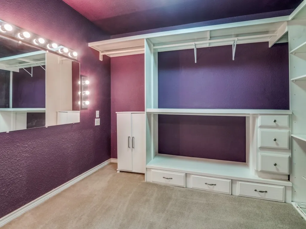 Custom closet with stackable washer and dryer connection.