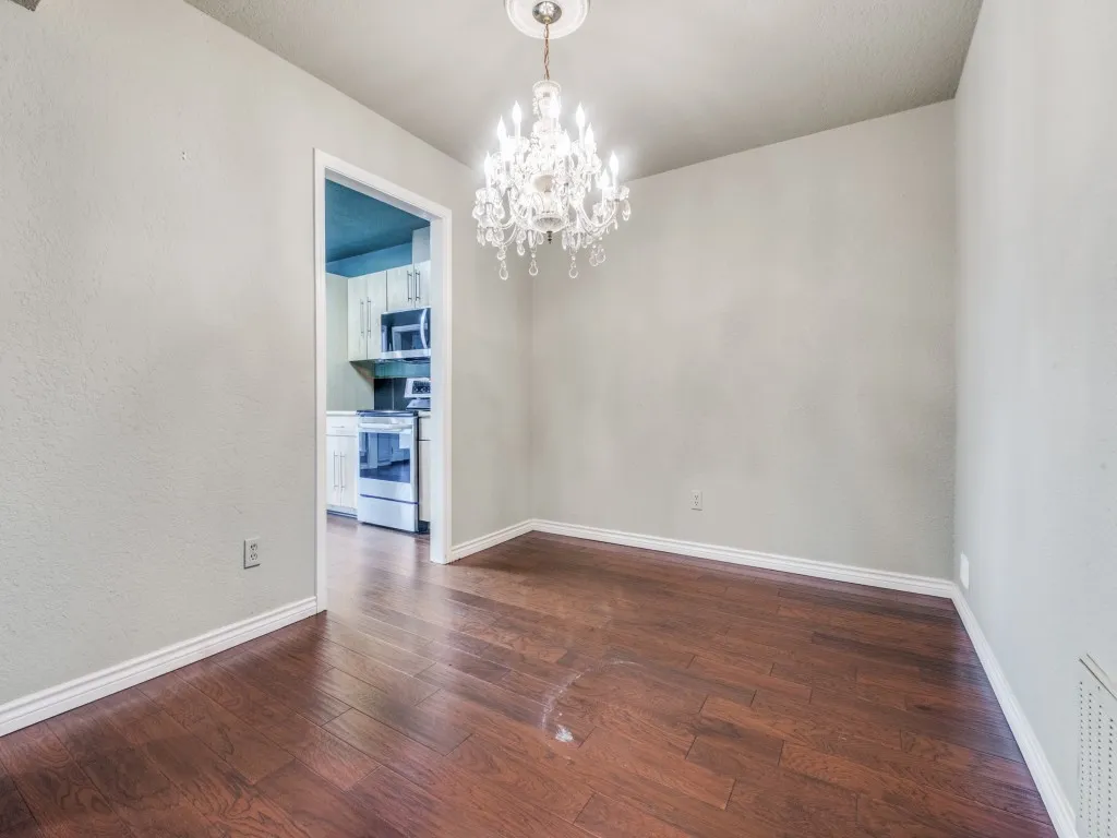 Formal dining room featuring a chandelier and dark wood finished floors