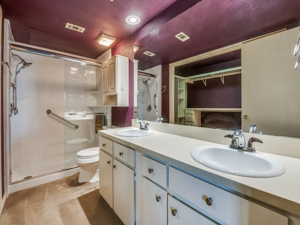 Full bathroom with a walk-in shower stall, double vanity, and recessed lighting and custom closet.