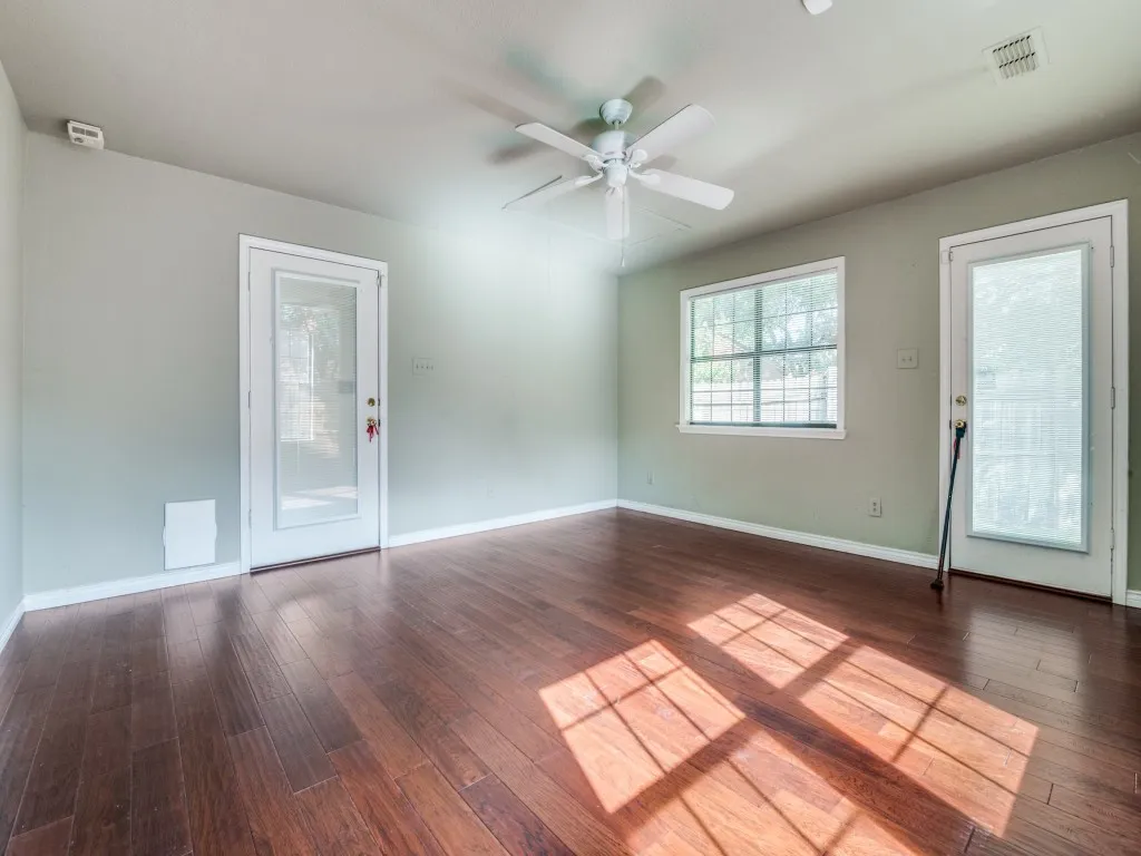 Unfurnished room with hardwood / wood-style flooring and ceiling fan