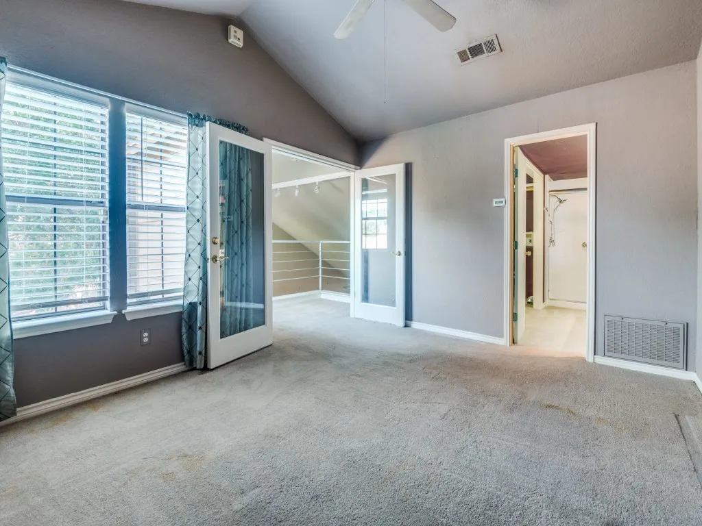 Primary bedroom with loft area and French doors.