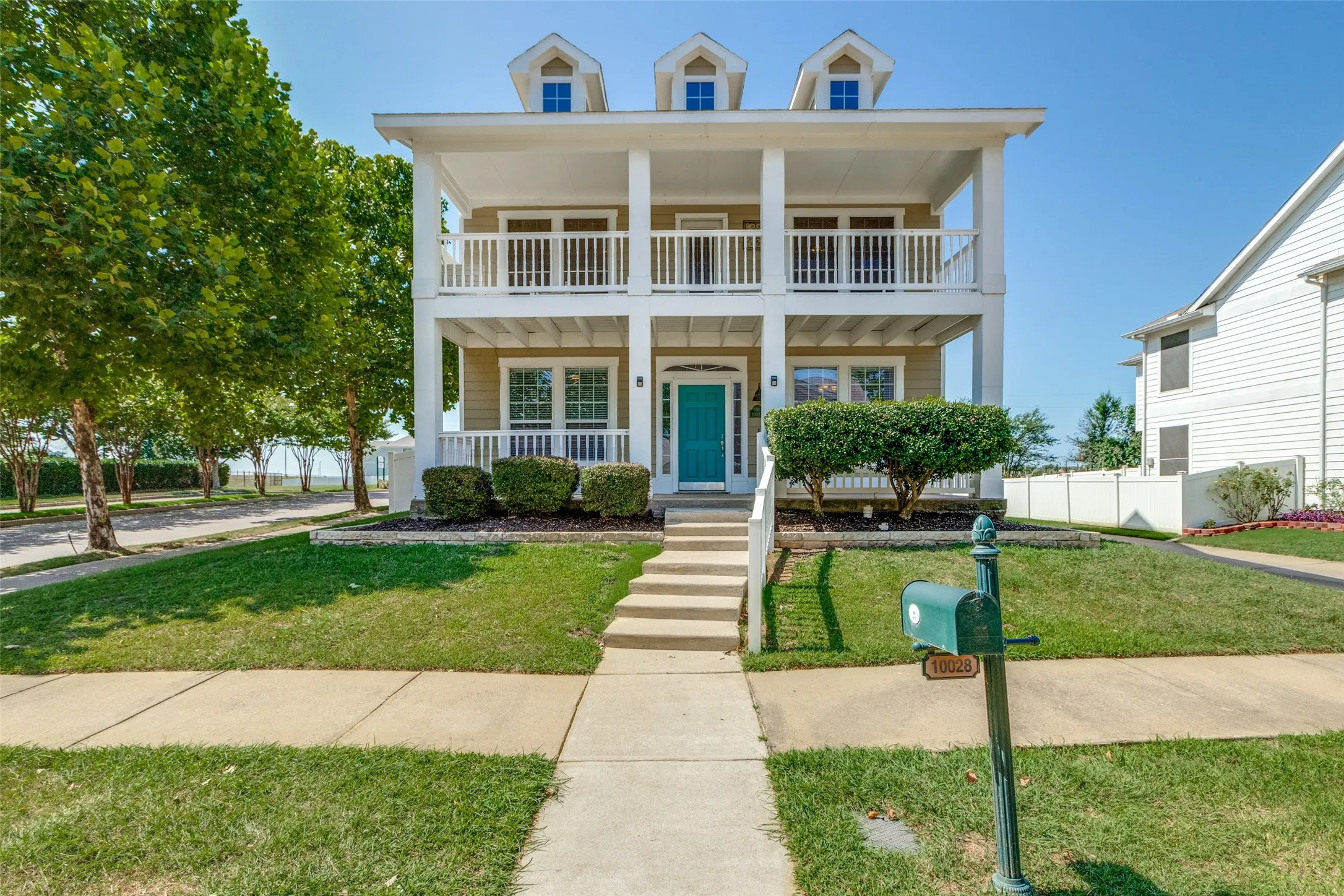 View of front of house with covered porch and a balcony