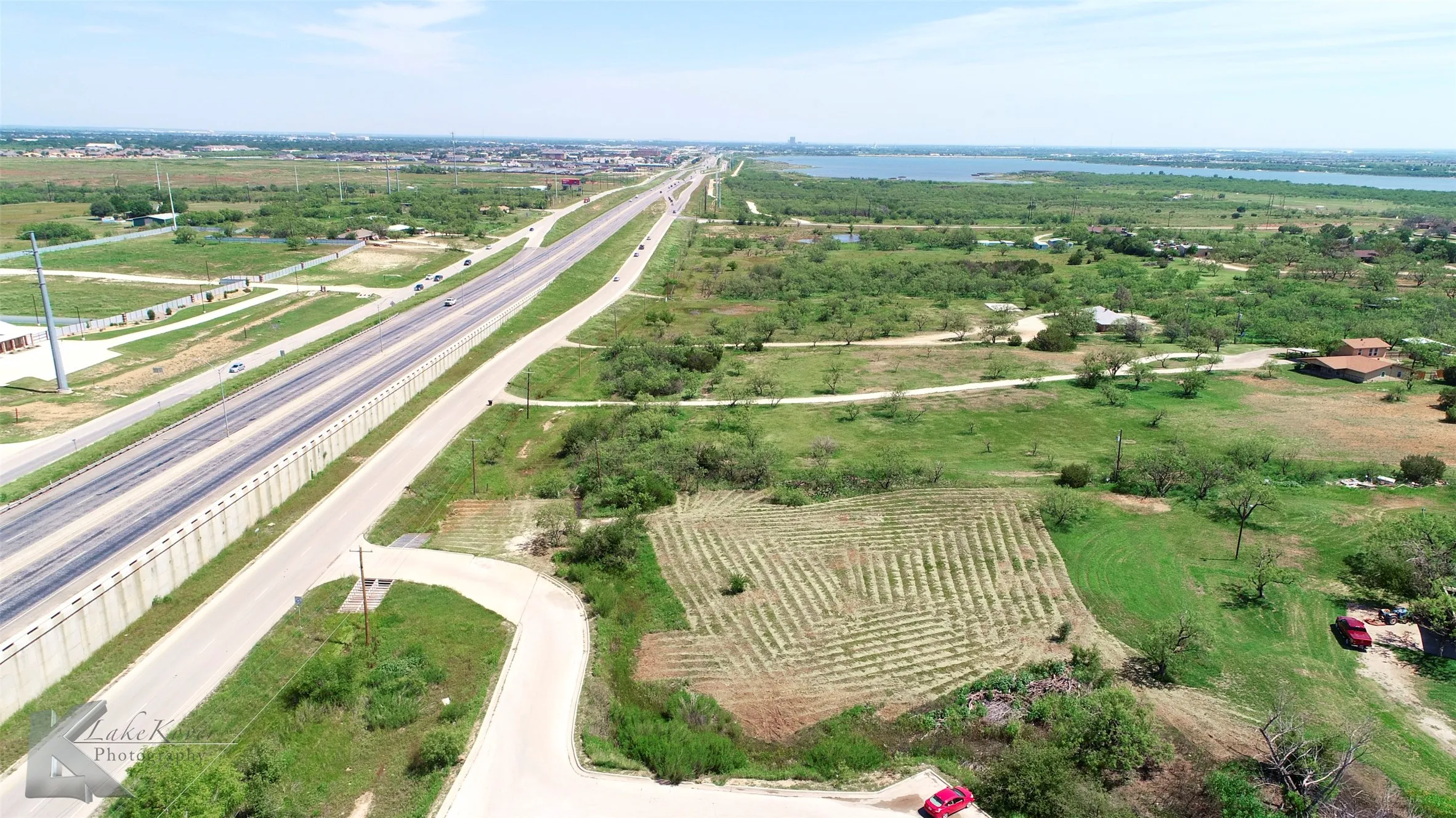 Aerial view of sparsely populated area with a large body of water and abundant farmland