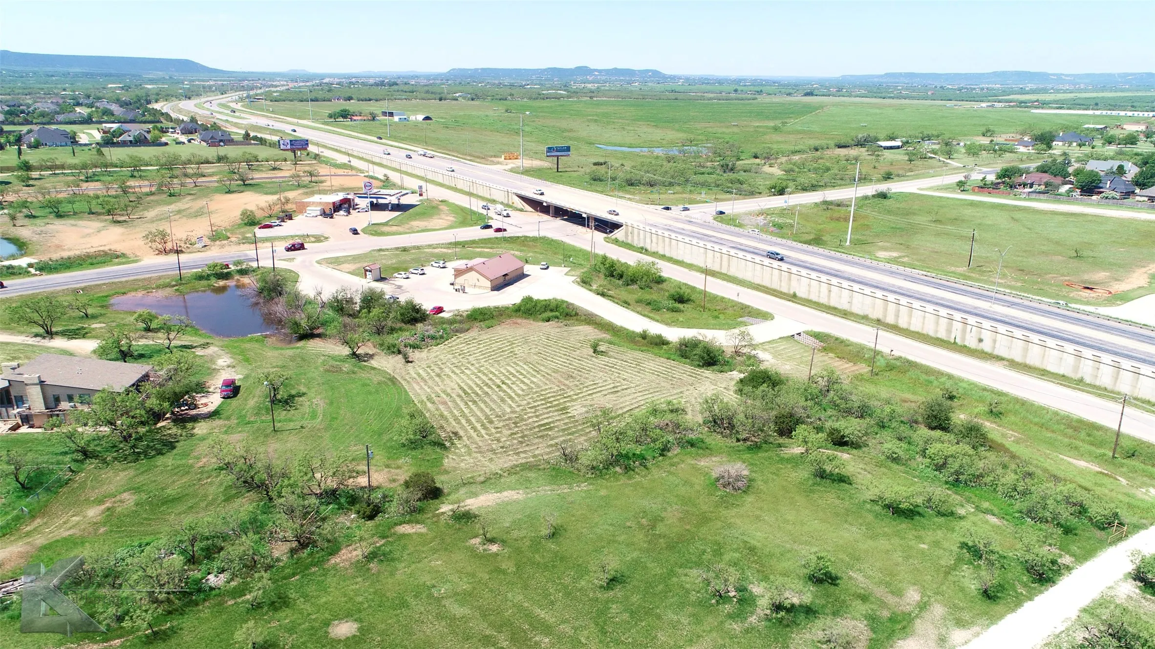 Aerial overview of property's location featuring rural landscape and a major roadway