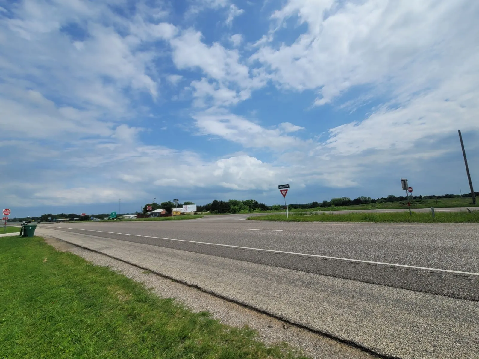 View of asphalt street with traffic signs