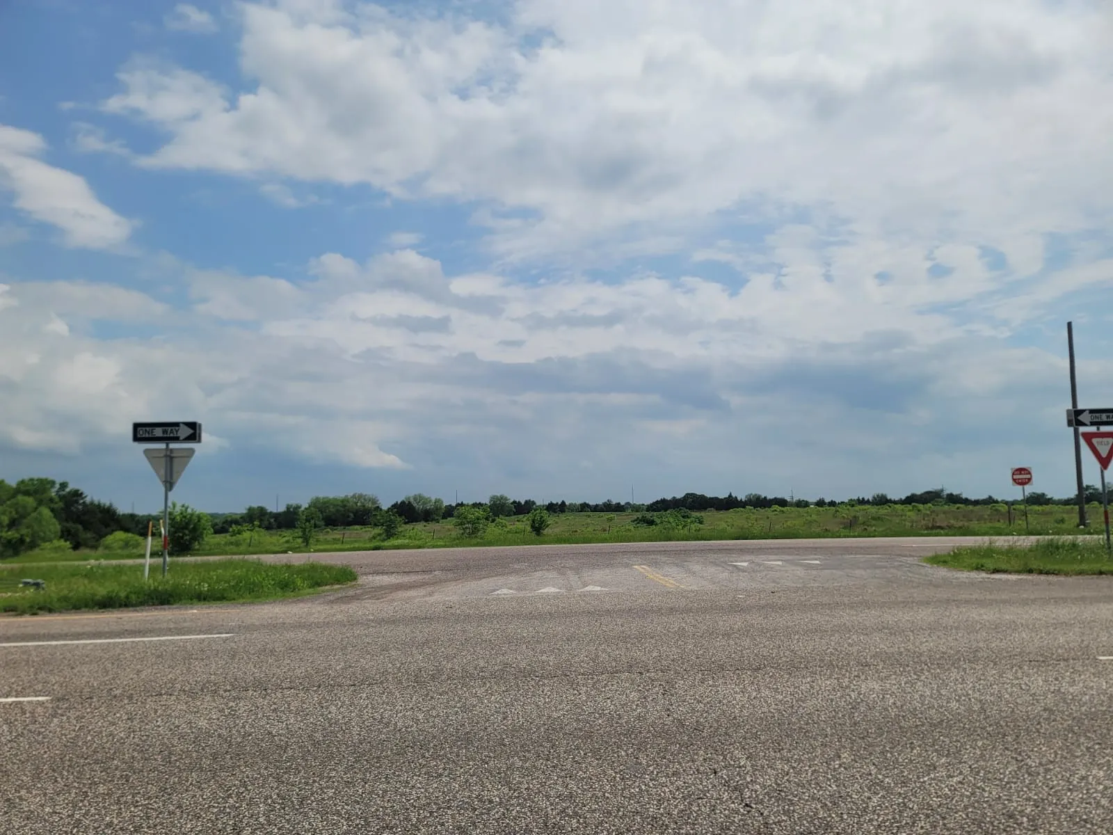 View of asphalt road with traffic signs