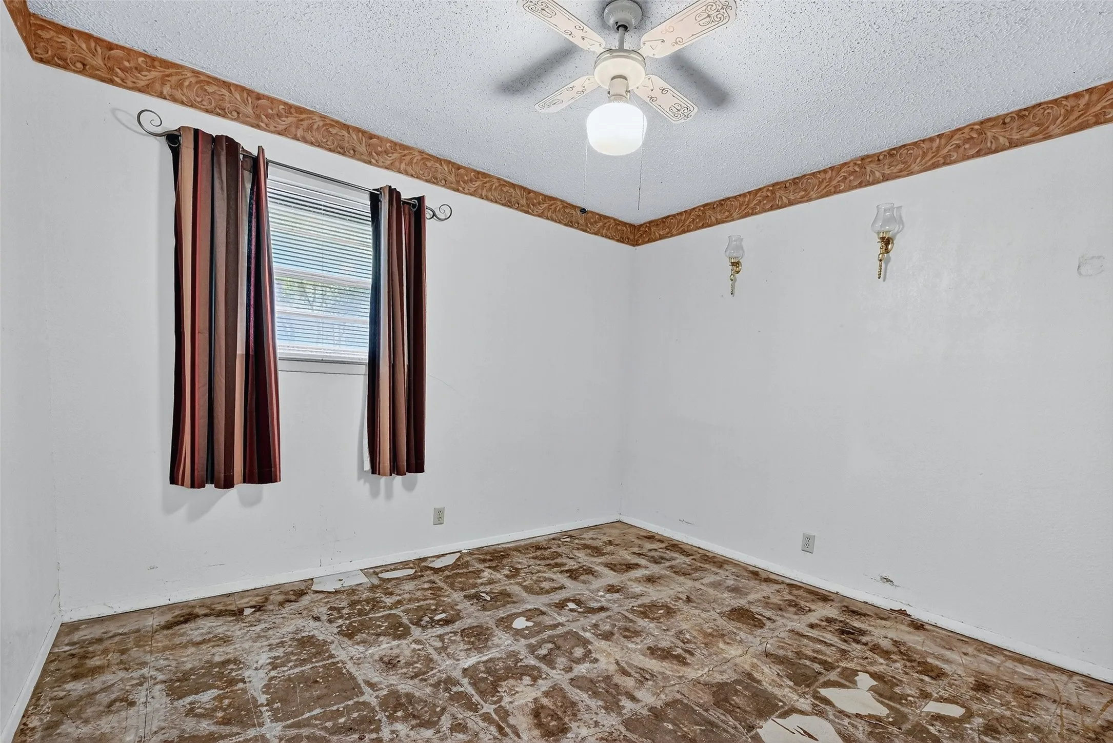 Spare room featuring a textured ceiling and ceiling fan