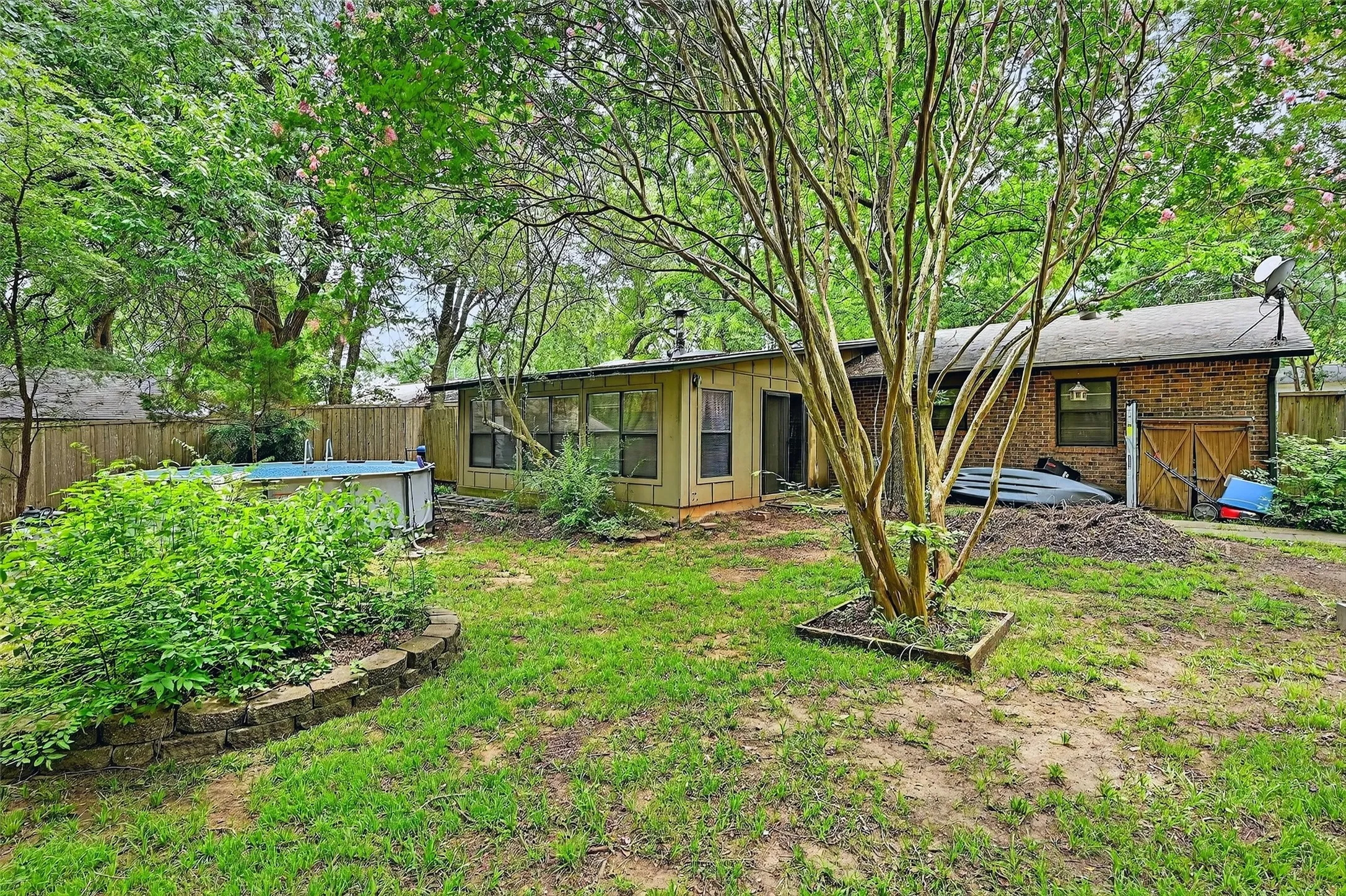 Fenced backyard with a sunroom