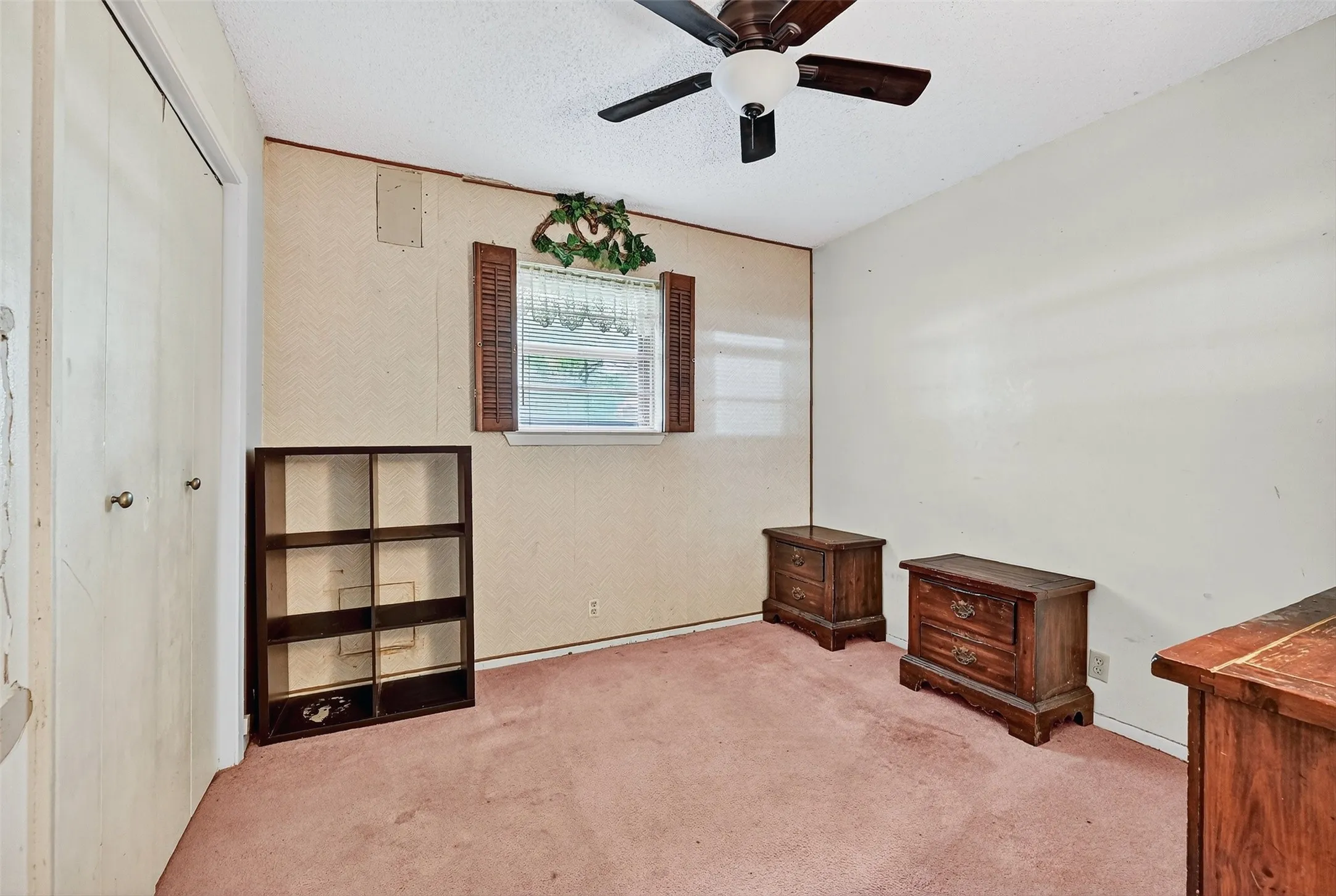 Unfurnished bedroom featuring carpet flooring, a closet, and ceiling fan