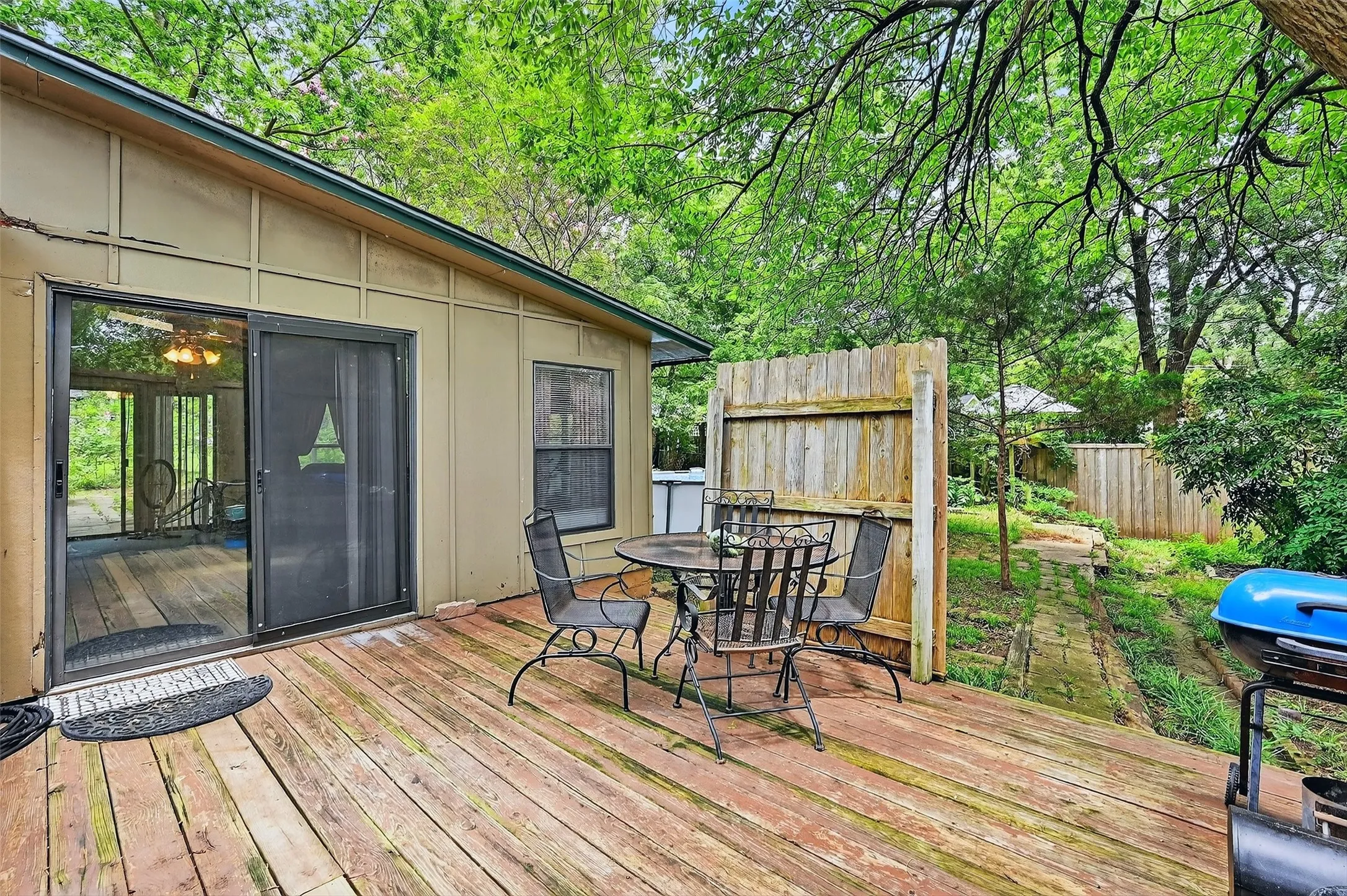 Wooden deck featuring outdoor dining space and grilling area