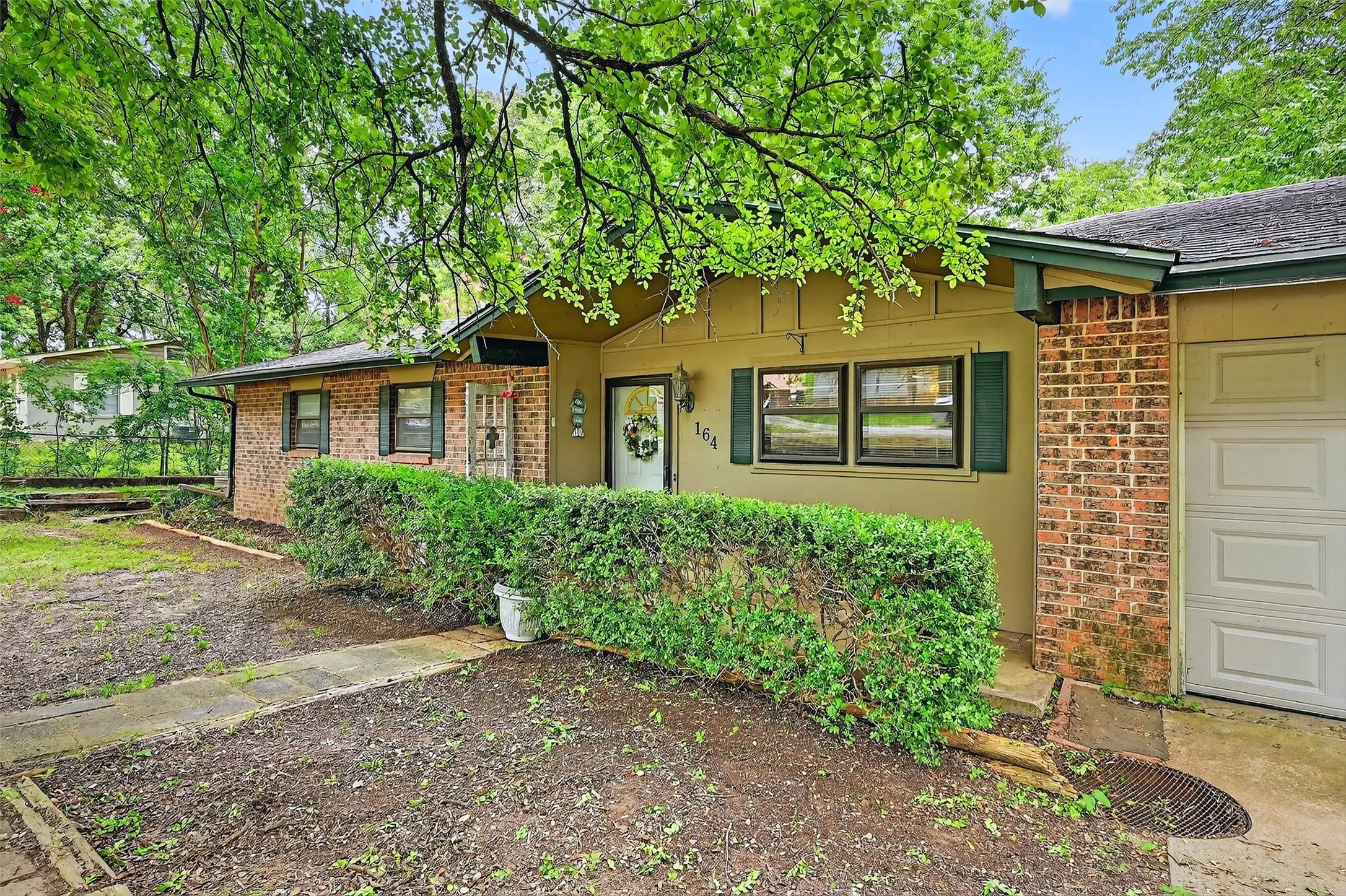 Single story home featuring brick siding