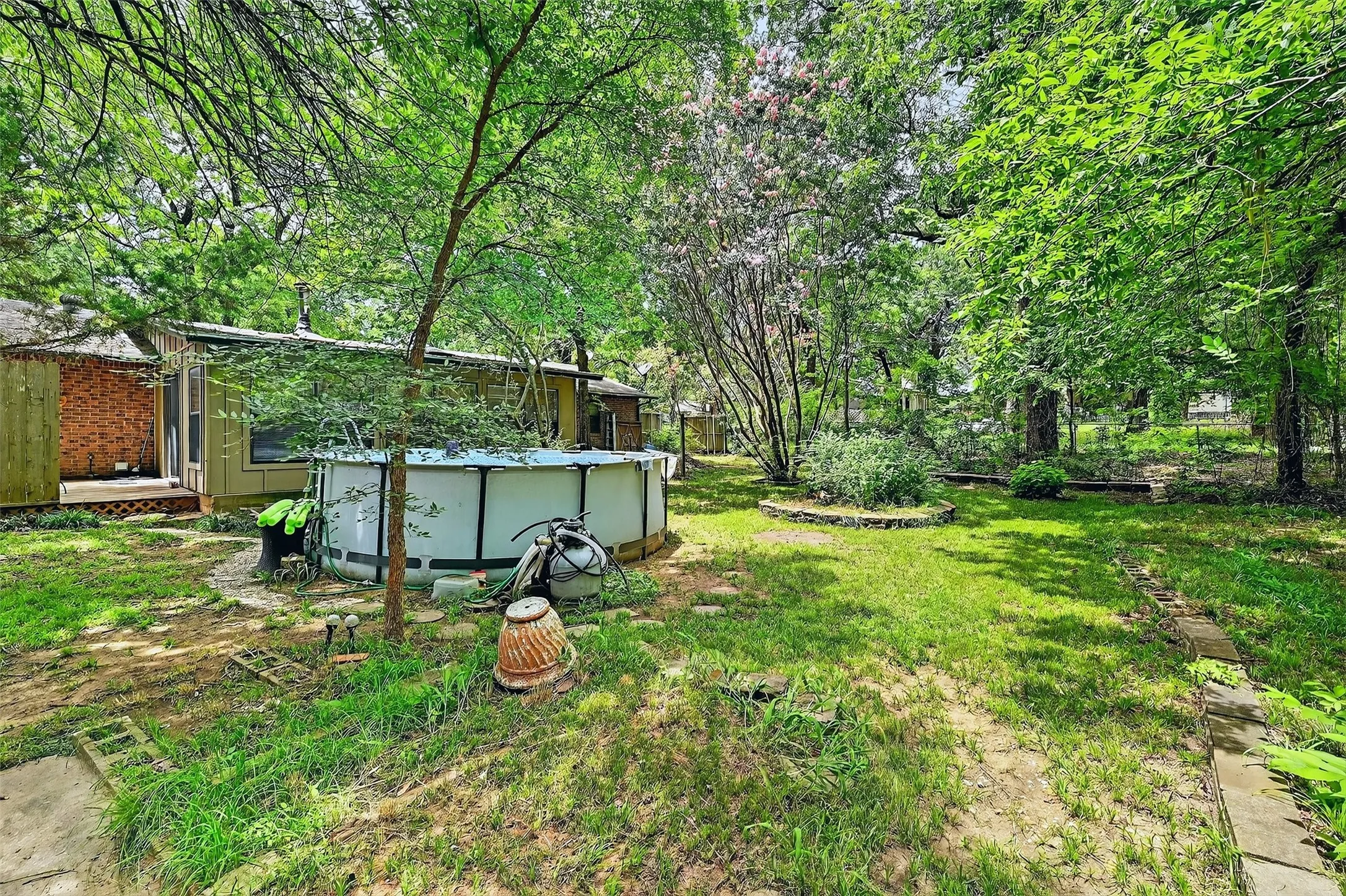 View of green lawn with an outdoor pool