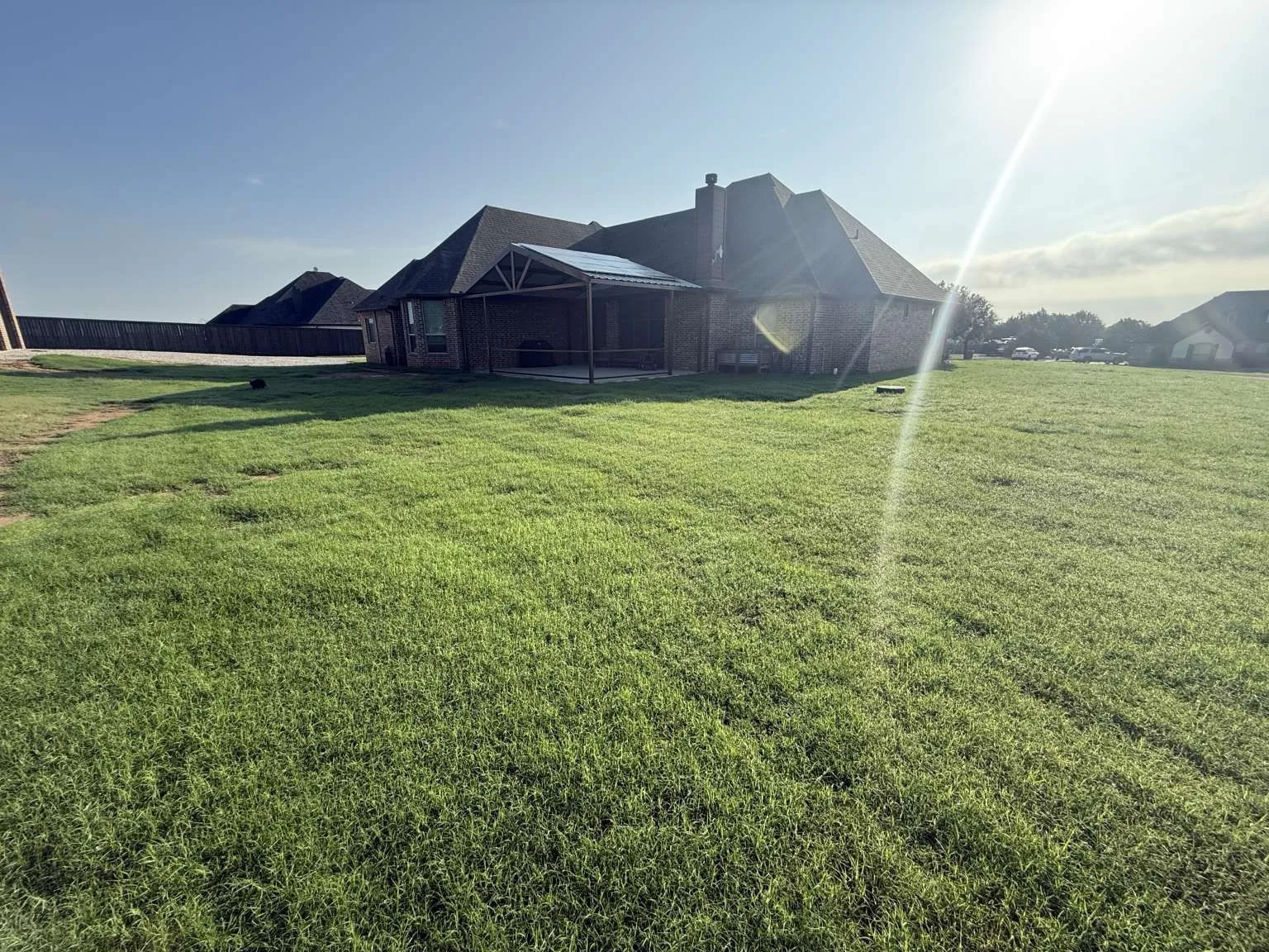 View of green lawn with a lanai