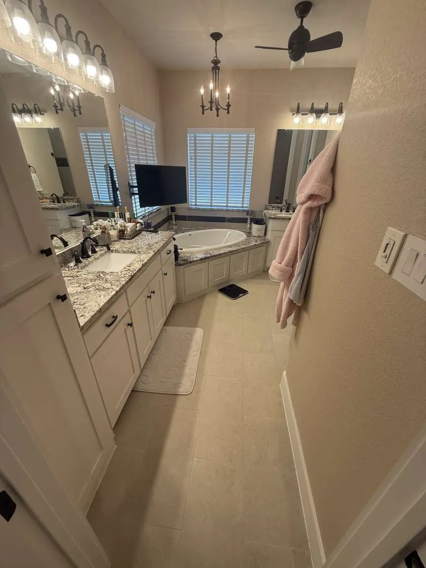 Full bathroom with a bath, vanity, a chandelier, ceiling fan, and tile patterned flooring