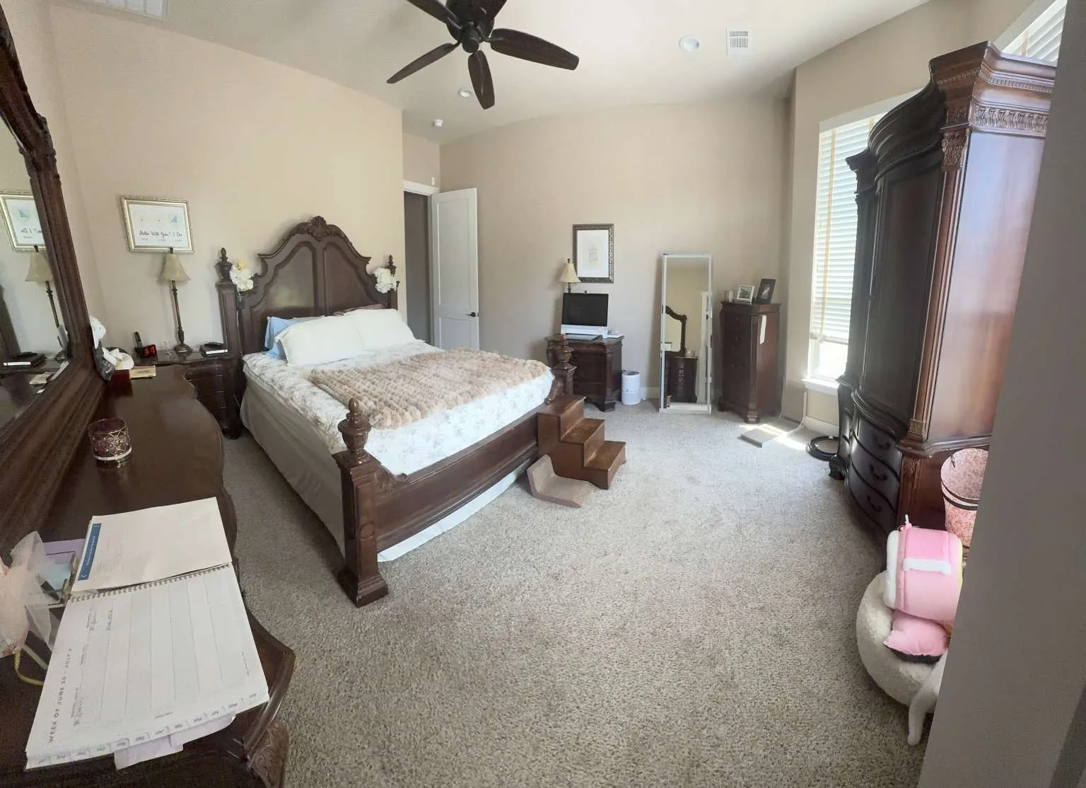 Carpeted bedroom with a ceiling fan and recessed lighting
