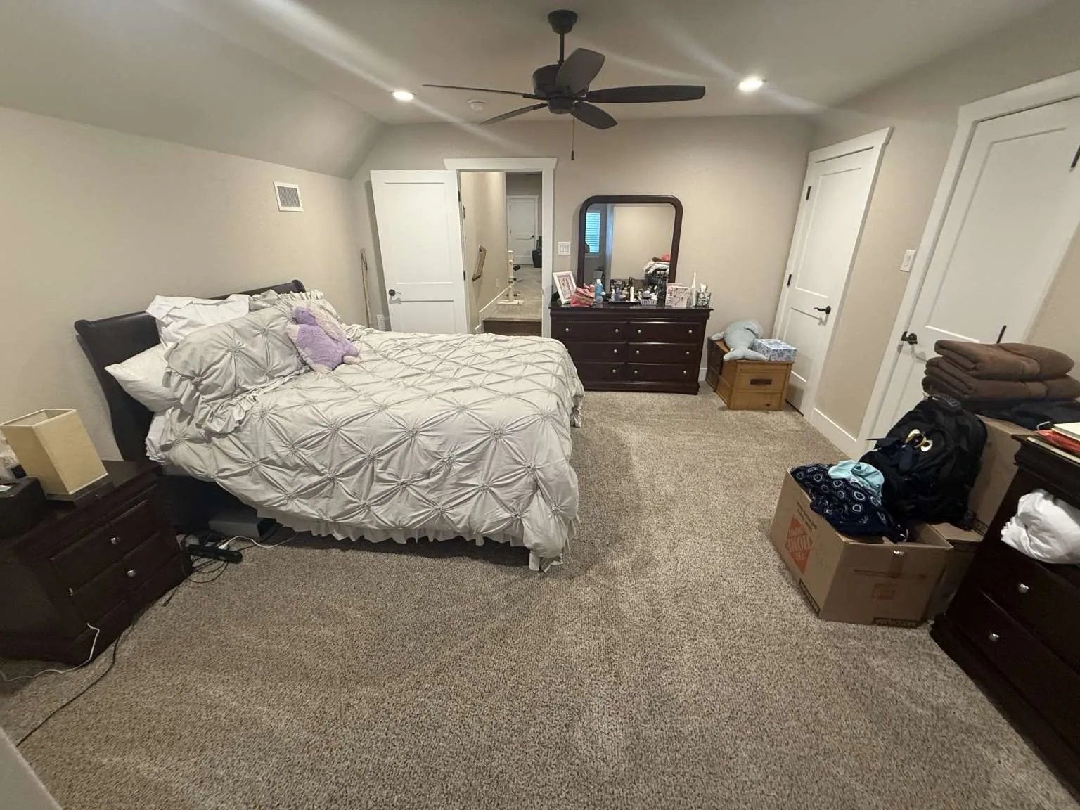 Carpeted bedroom featuring recessed lighting, vaulted ceiling, and a ceiling fan