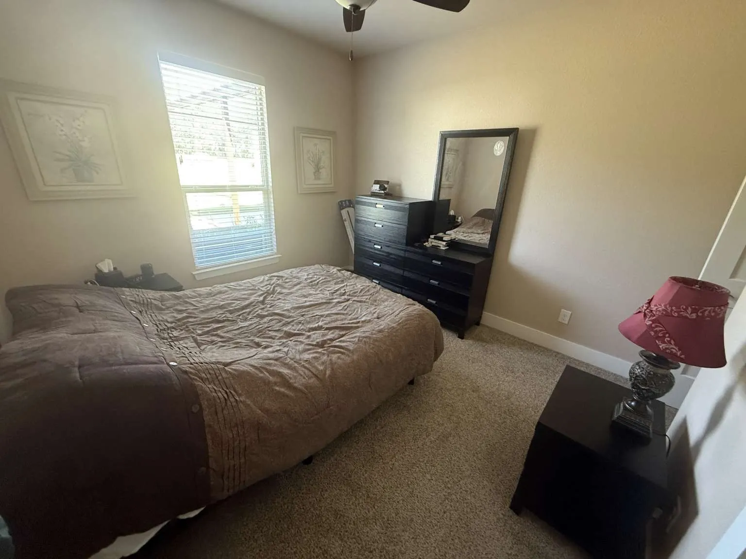 Carpeted bedroom with baseboards and a ceiling fan