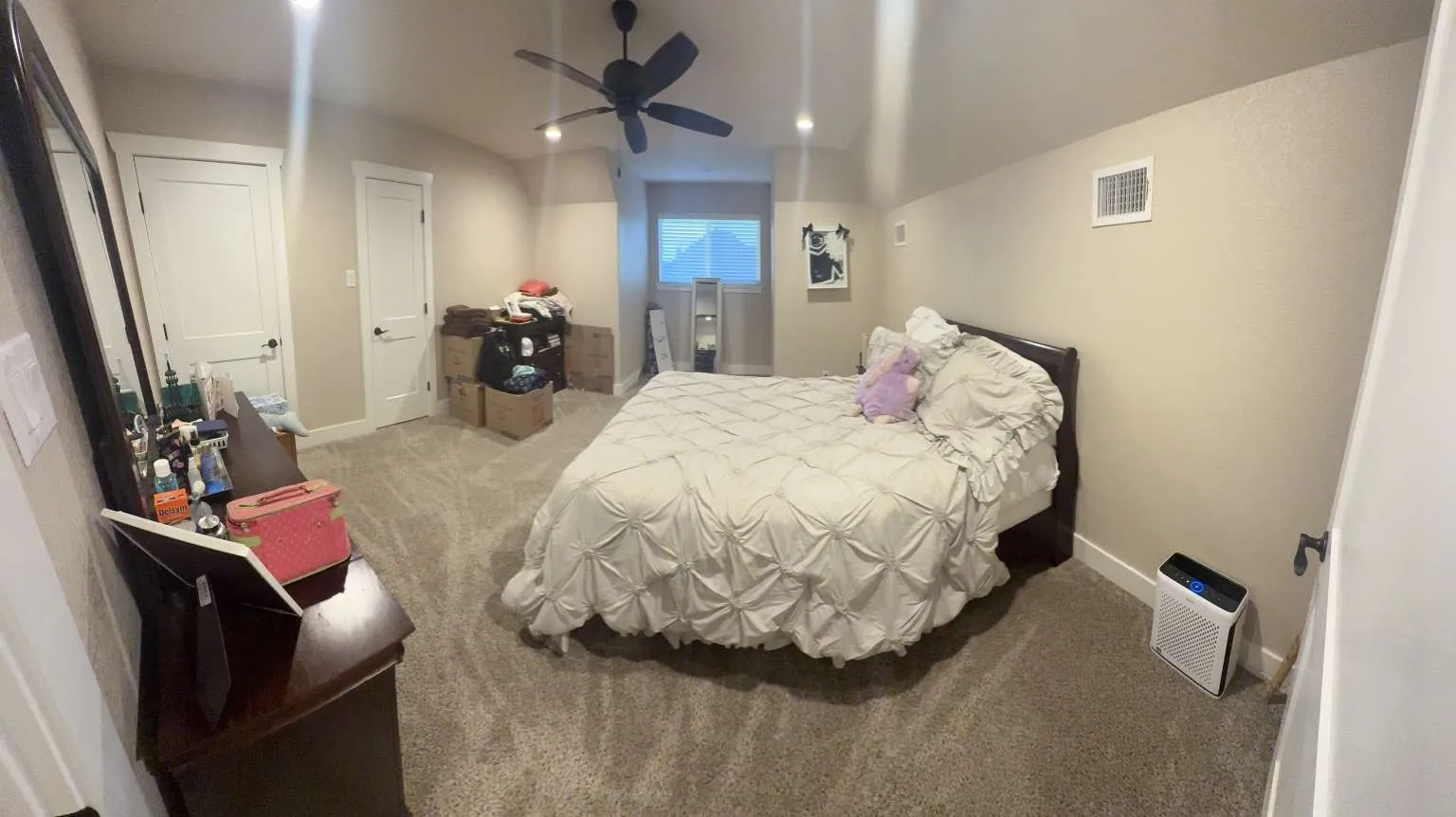 Carpeted bedroom featuring baseboards and a ceiling fan