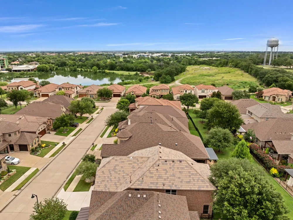 Aerial perspective of suburban area with a nearby body of water