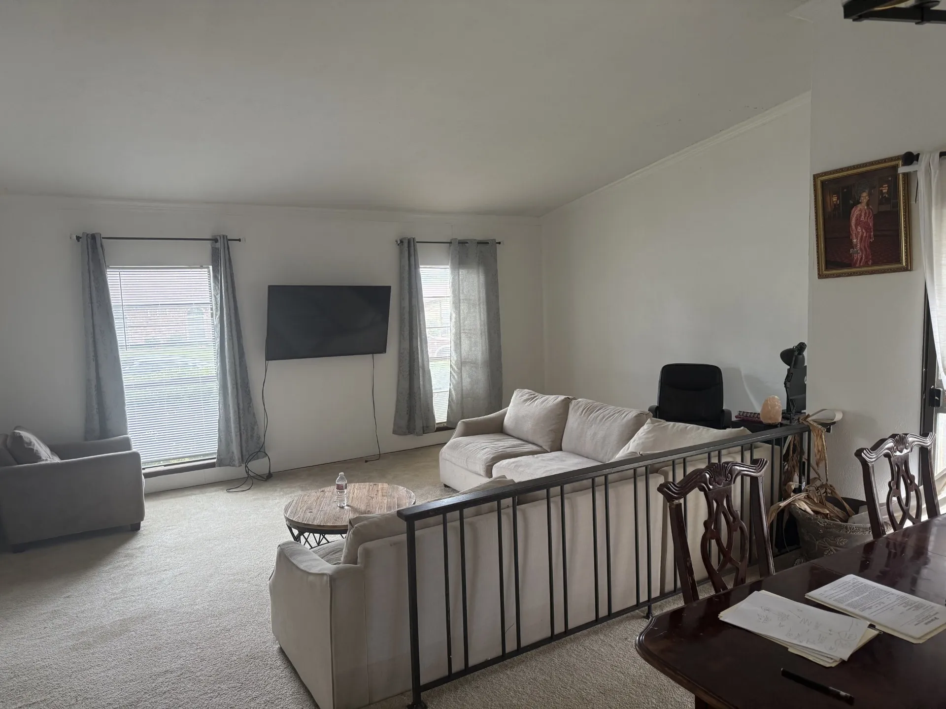 Living area featuring carpet flooring, plenty of natural light, ornamental molding, and vaulted ceiling