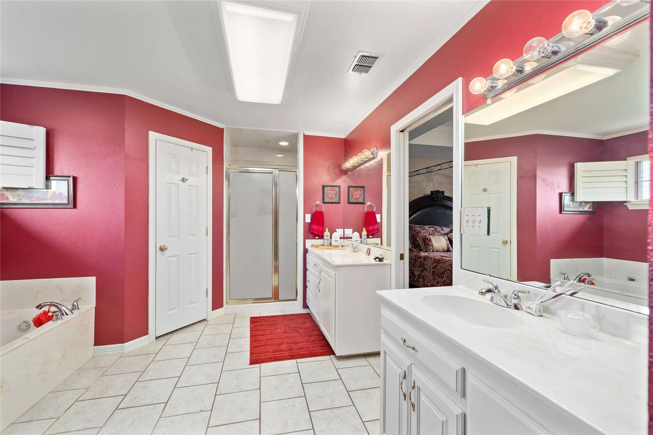 Double vanities, shower and his and her closets