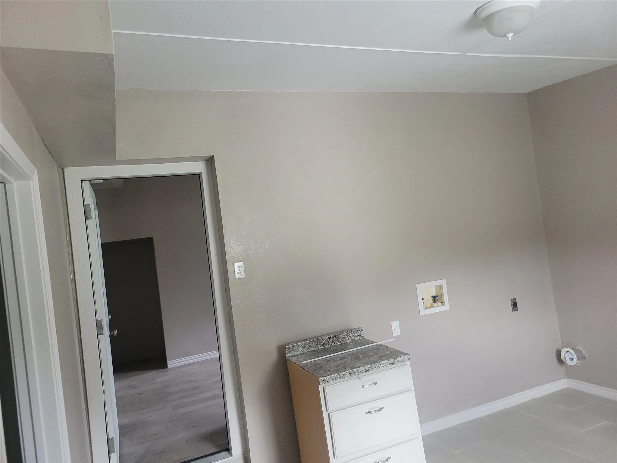 Laundry room featuring washer hookup and baseboards