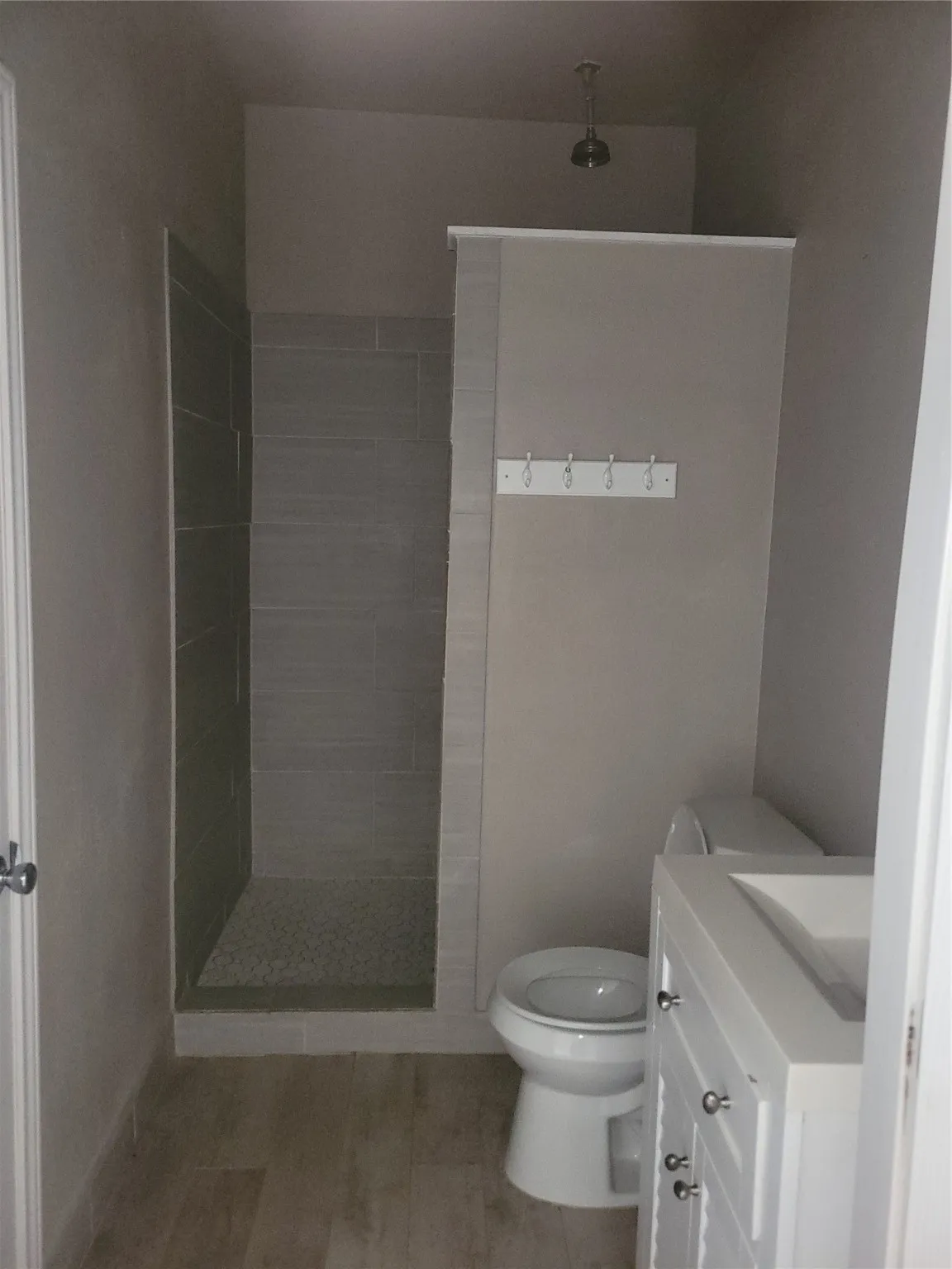 Bathroom featuring vanity, walk in shower, and tile patterned floors