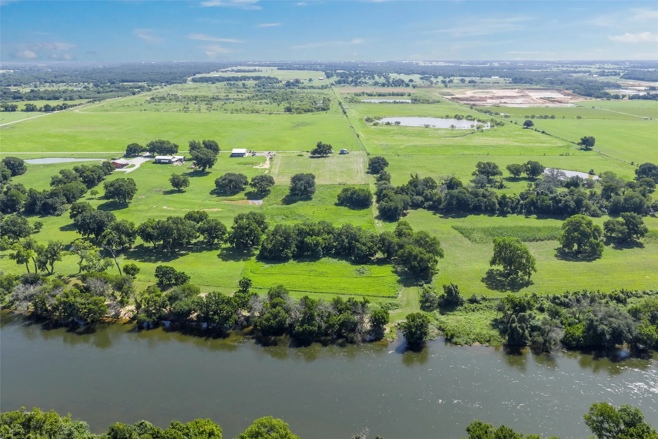 Overview of rural landscape with a nearby body of water