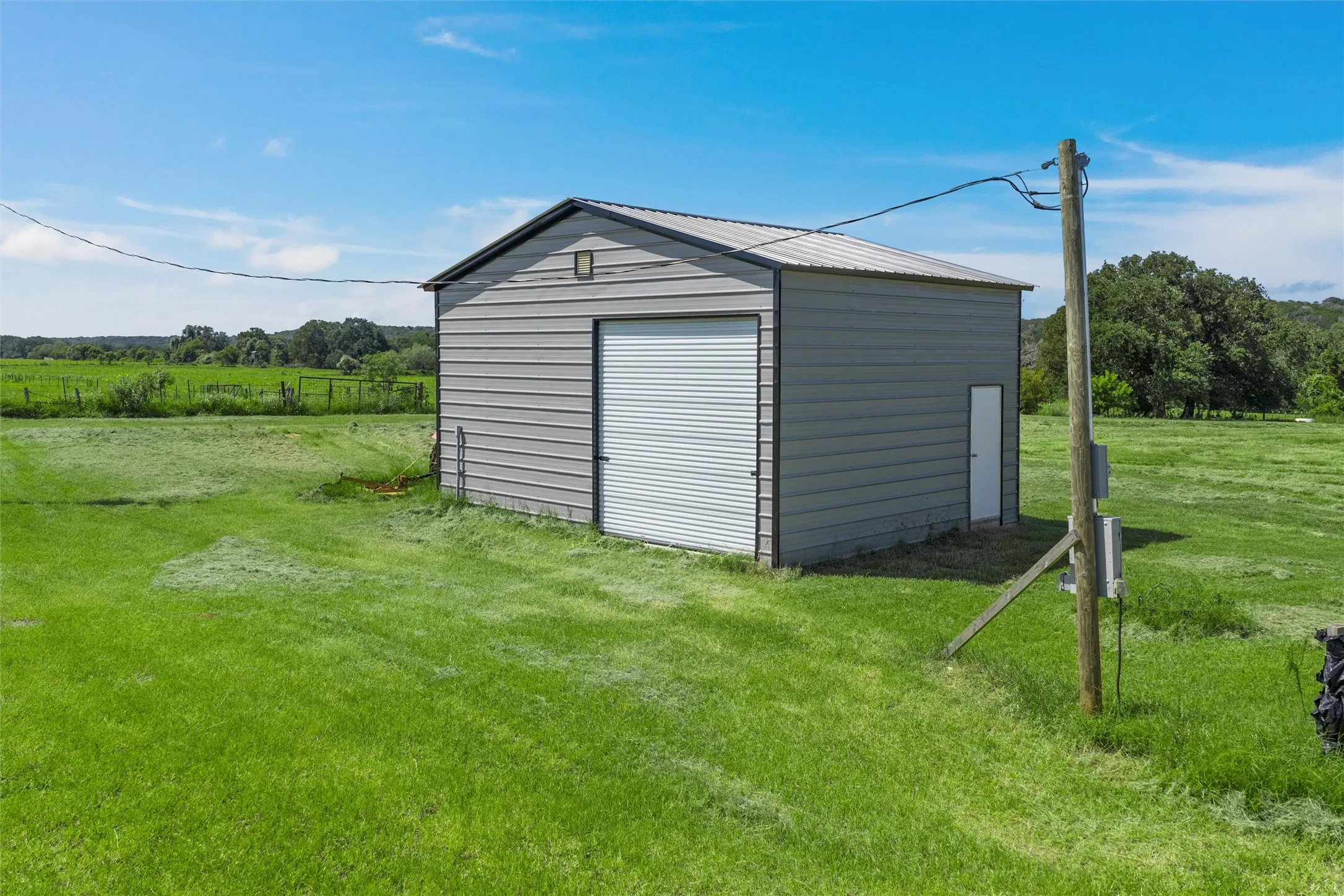 View of outbuilding with a rural view